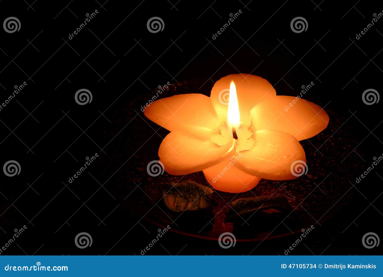 Flower-shaped Candle Burning On A Black Background Stock Photo - Image