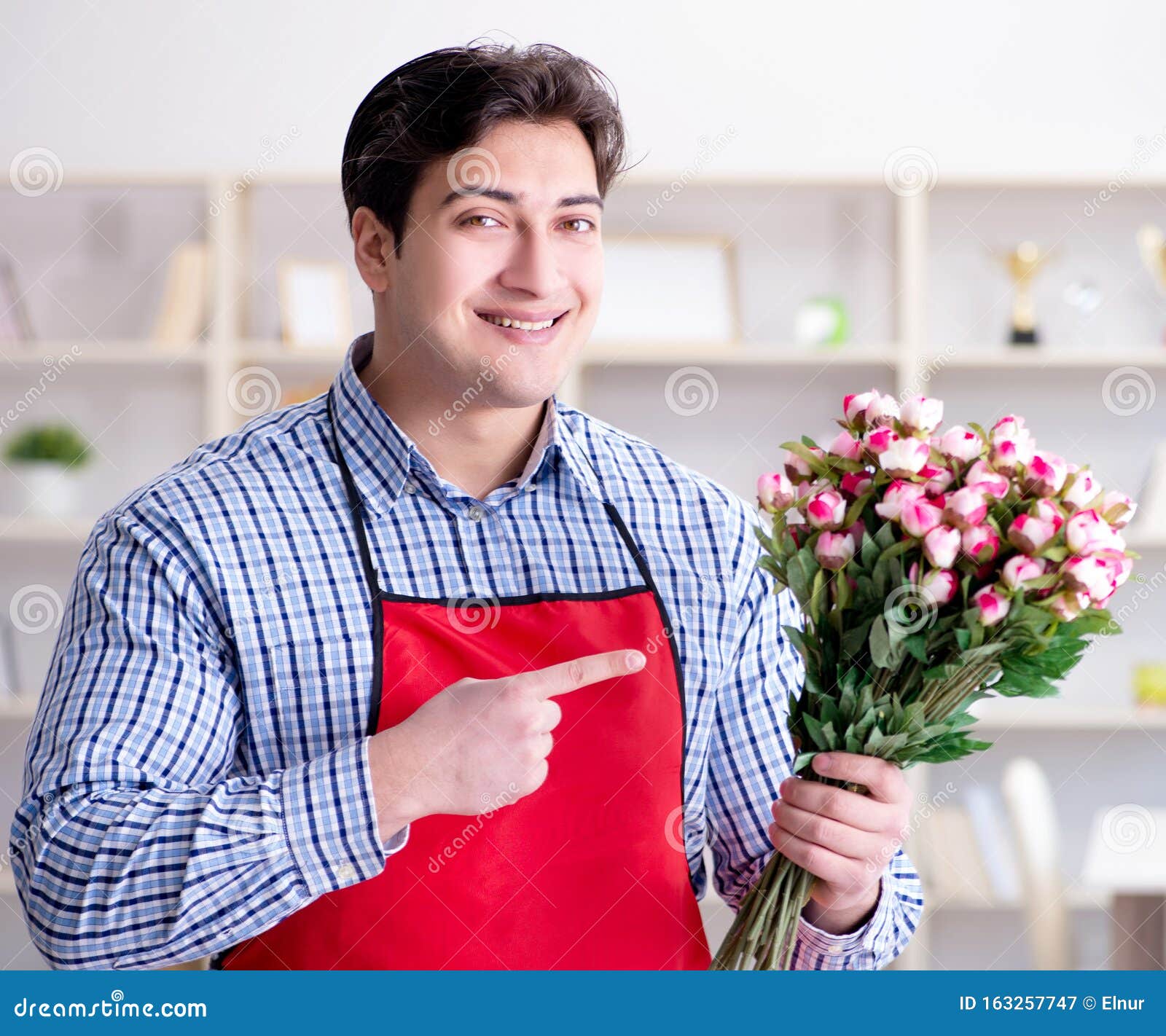 Flower Shop Assistant Offering a Bunch of Flowers Stock Image Image