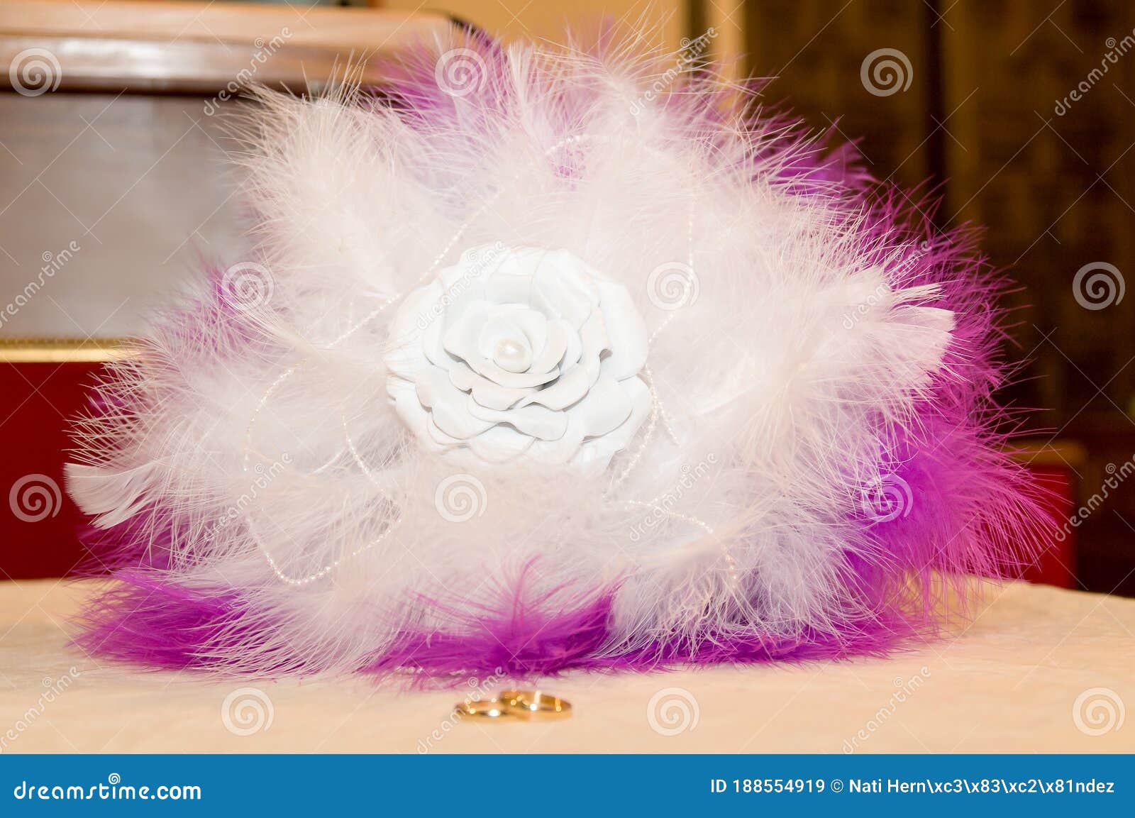 bridal bouquet made of white and purple feathers with a fabric flower in the center.