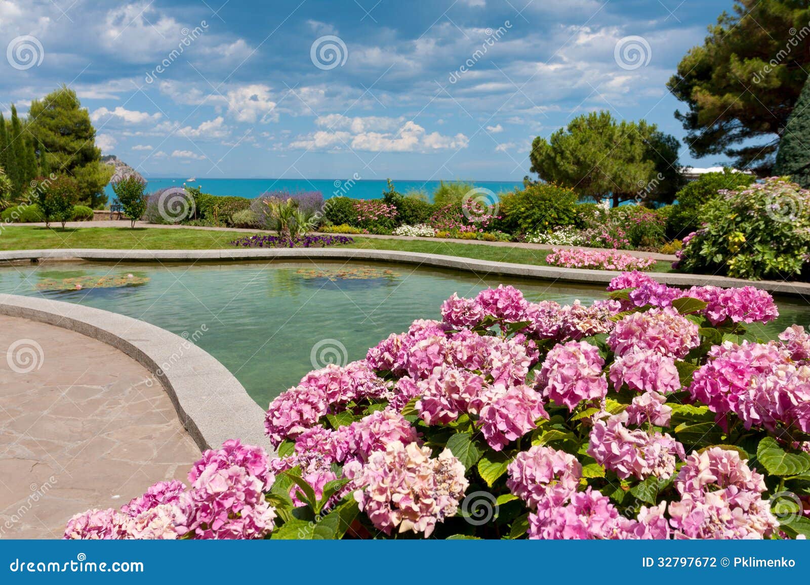 Flowers near pond in park stock photo. Image of summer 32797672