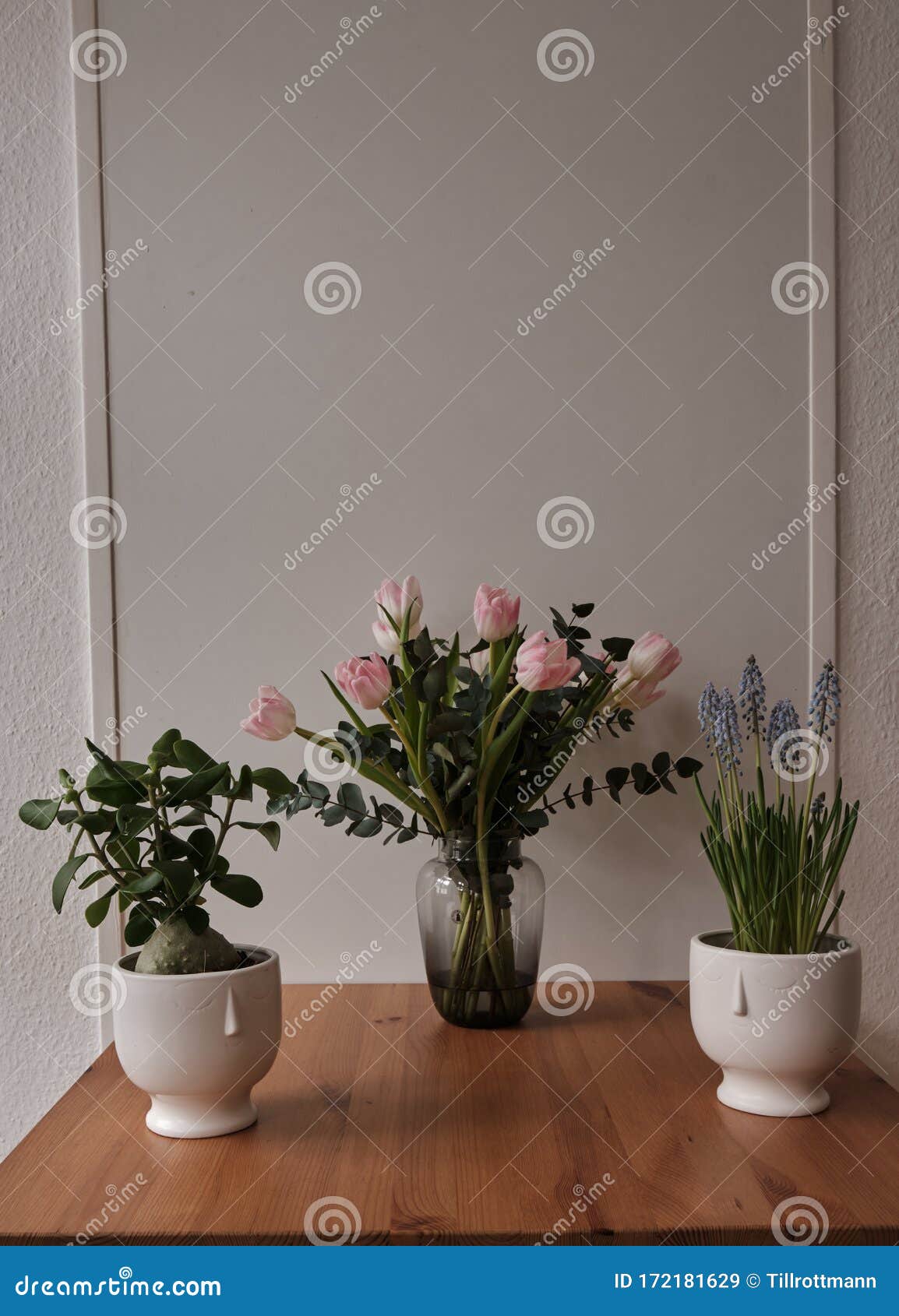 3 Flowers Stand On The Desk With Tulips In The Middle Stock Image