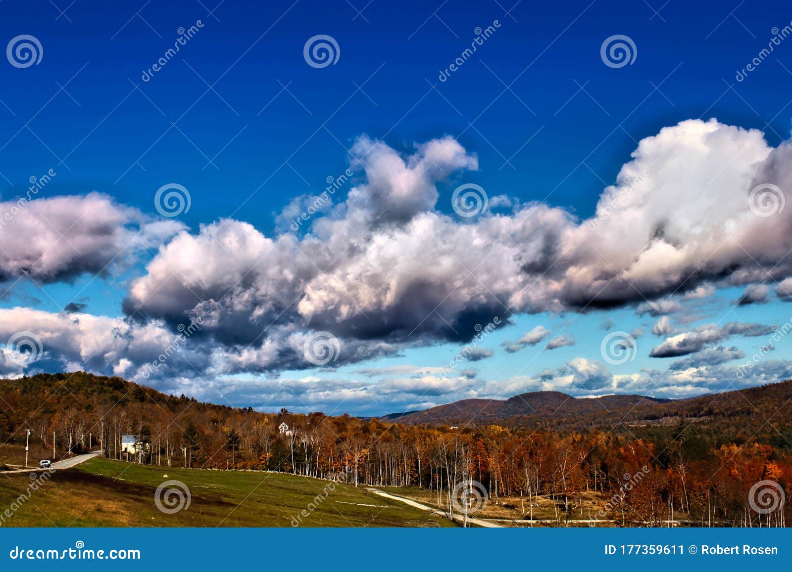 fluffy clouds over autumn colors