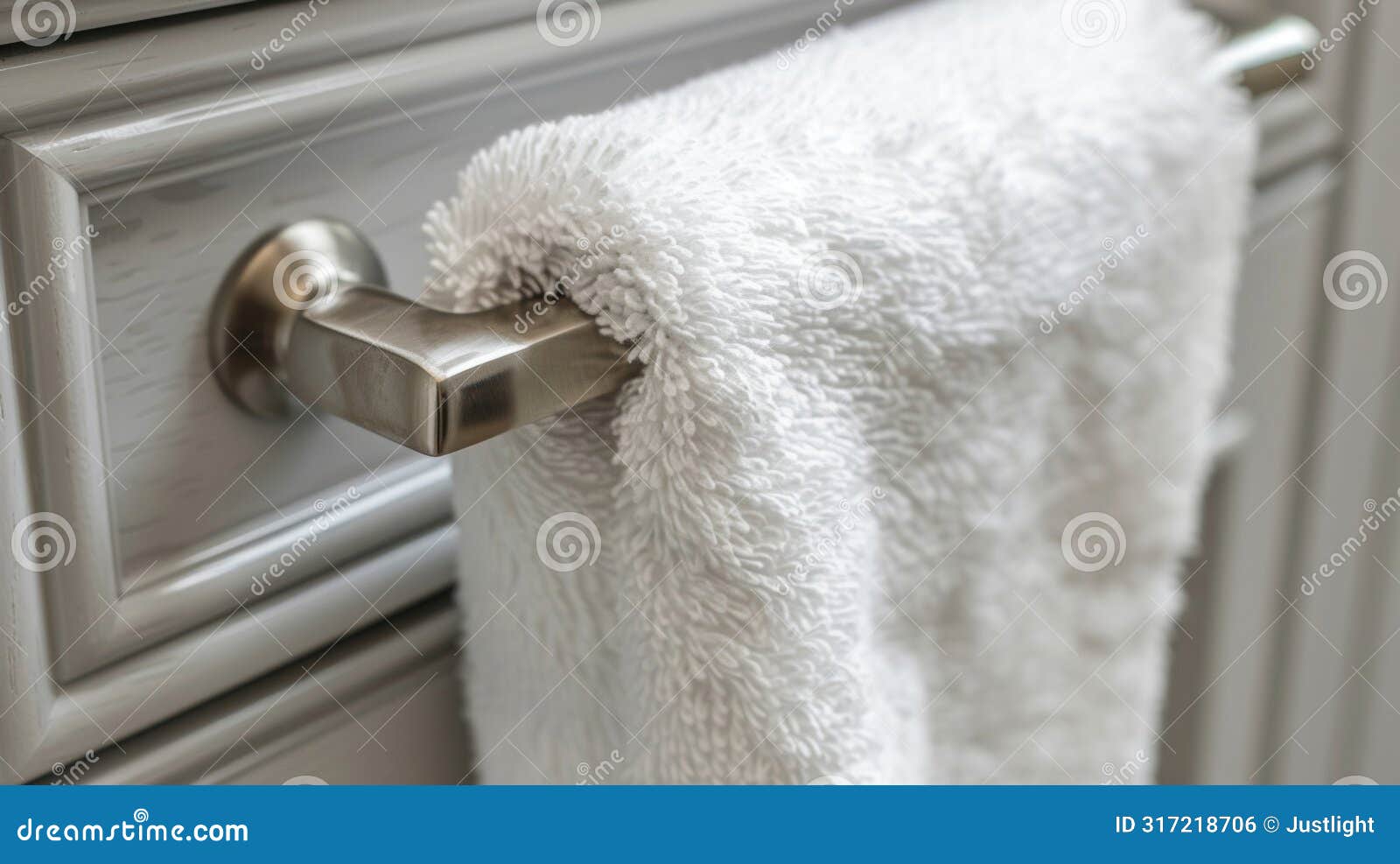 a fluffy kitchen towel dd over the door handle used to clean up any spills or messes