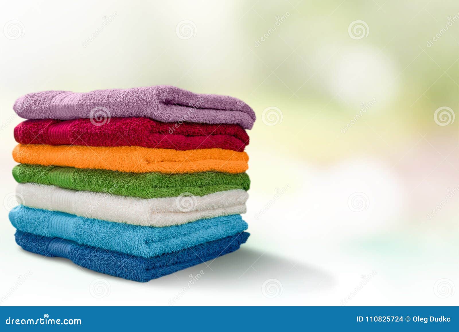 https://thumbs.dreamstime.com/z/fluffy-towels-group-objects-background-heap-clothing-pile-fluffy-colorful-towels-table-110825724.jpg