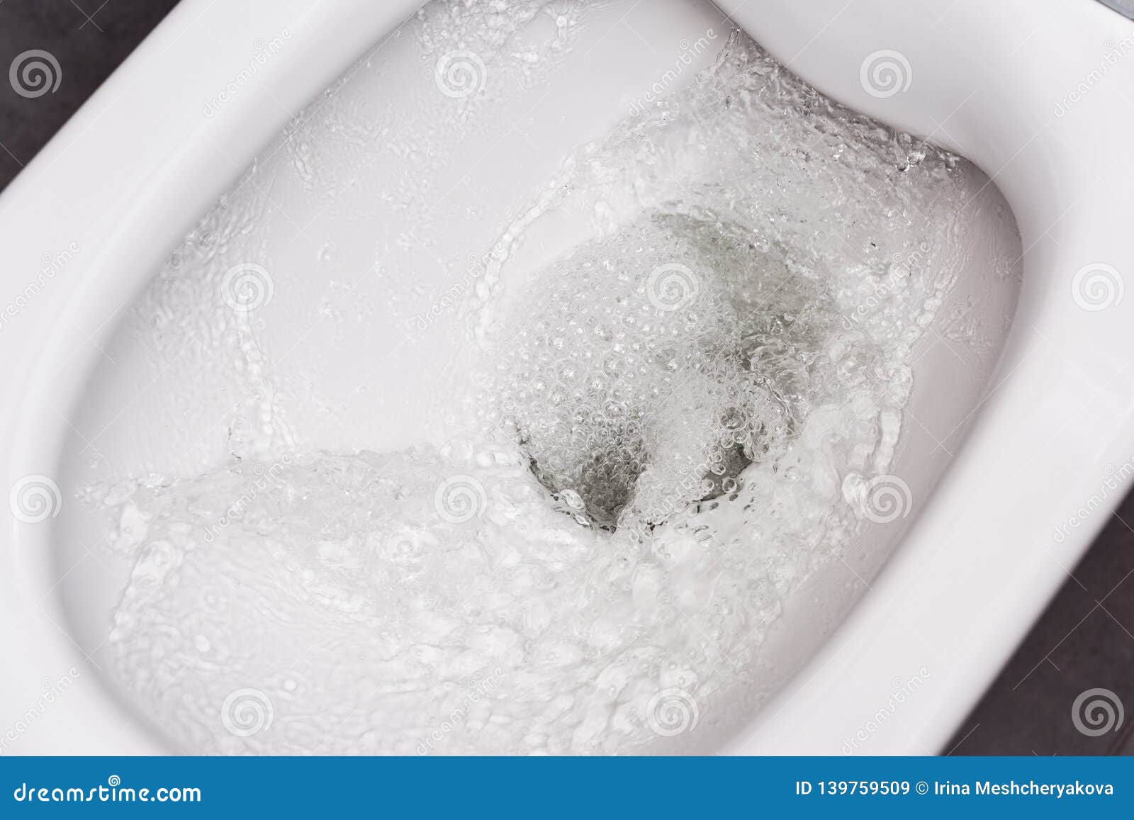 flush toilet. water flushes the toilet. the flow of water is clearly visible
