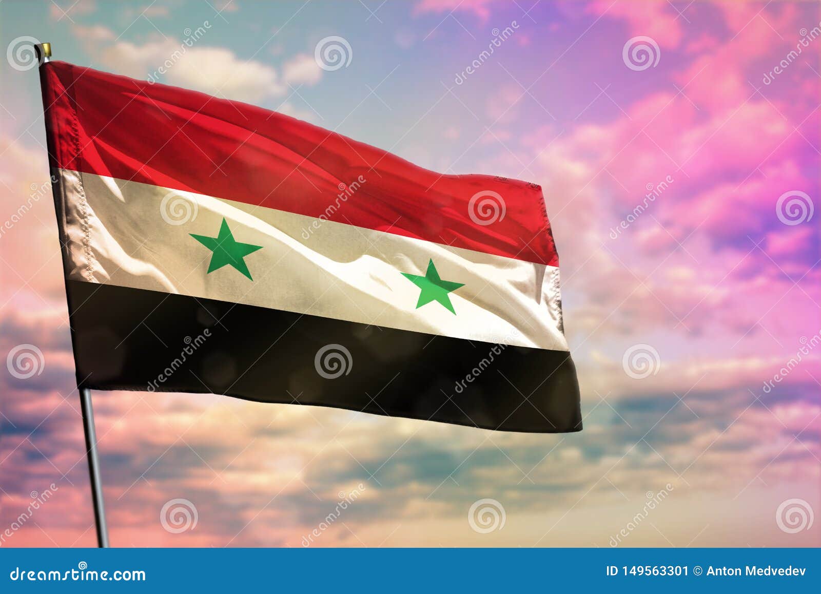 Flag of Syria on a Flagpole Flutters in the Wind Against the Sky