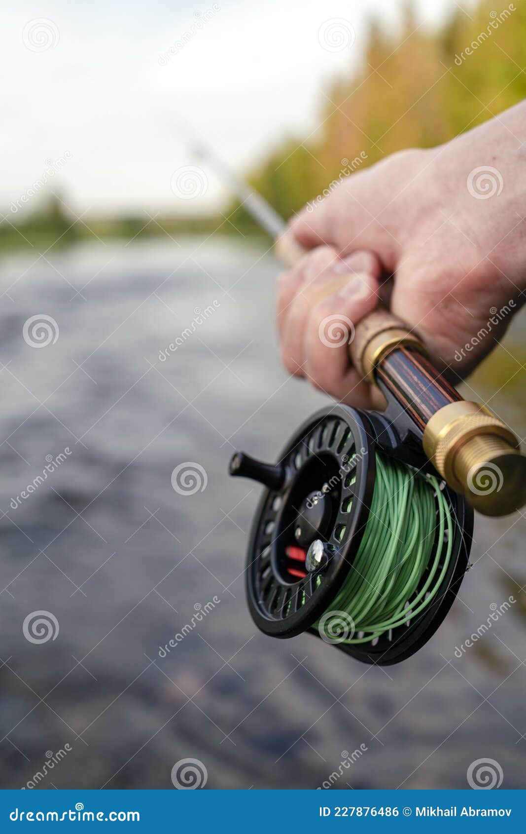 Fly Fishing Rod in Fisherman Hand. Fishing on the Mountain River