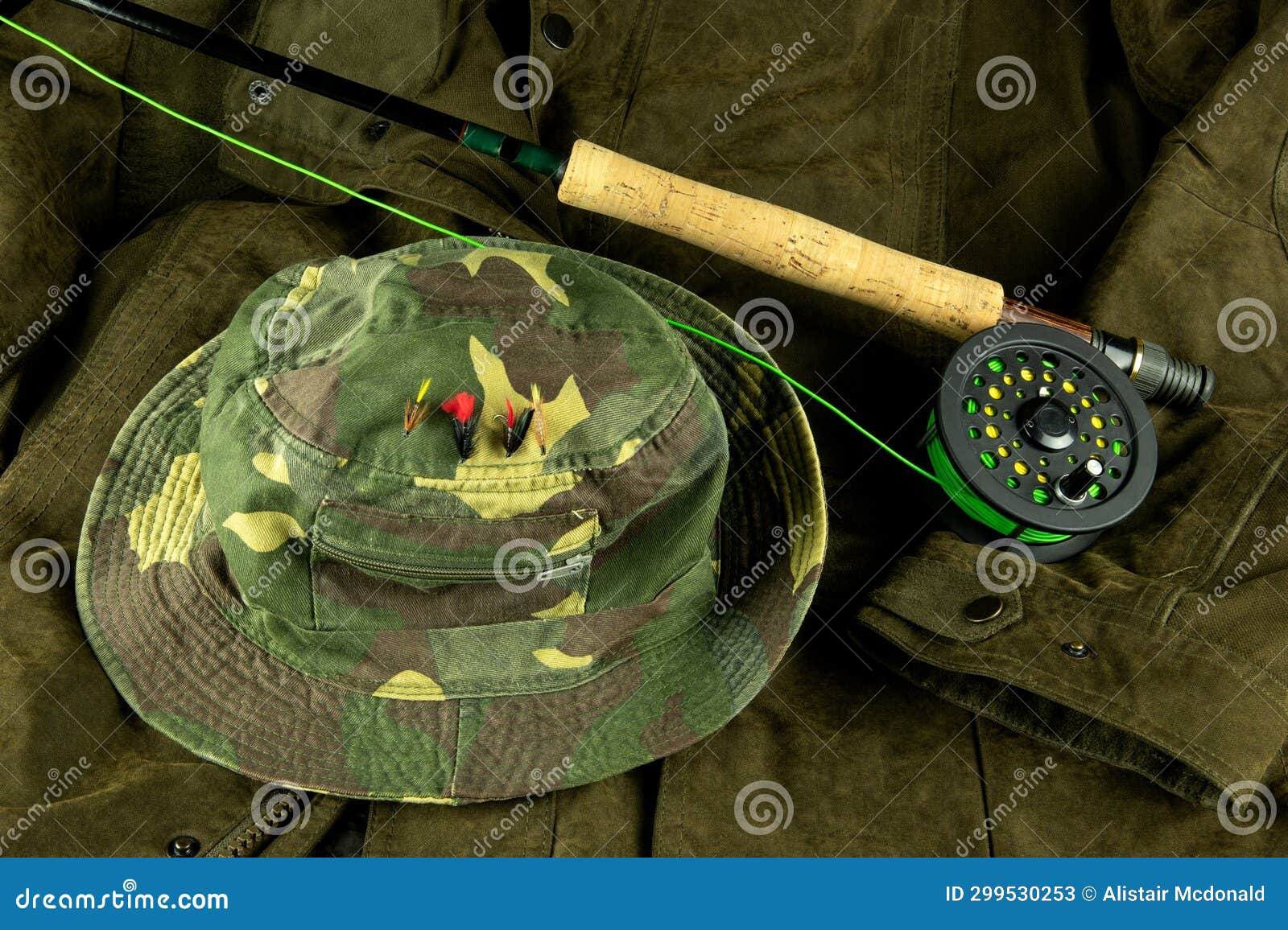 Fly Fishing Rod and Reel with Line on an Outdoor Coat with Fishing Hat and  Trout Flies Stock Image - Image of handle, angling: 299530253