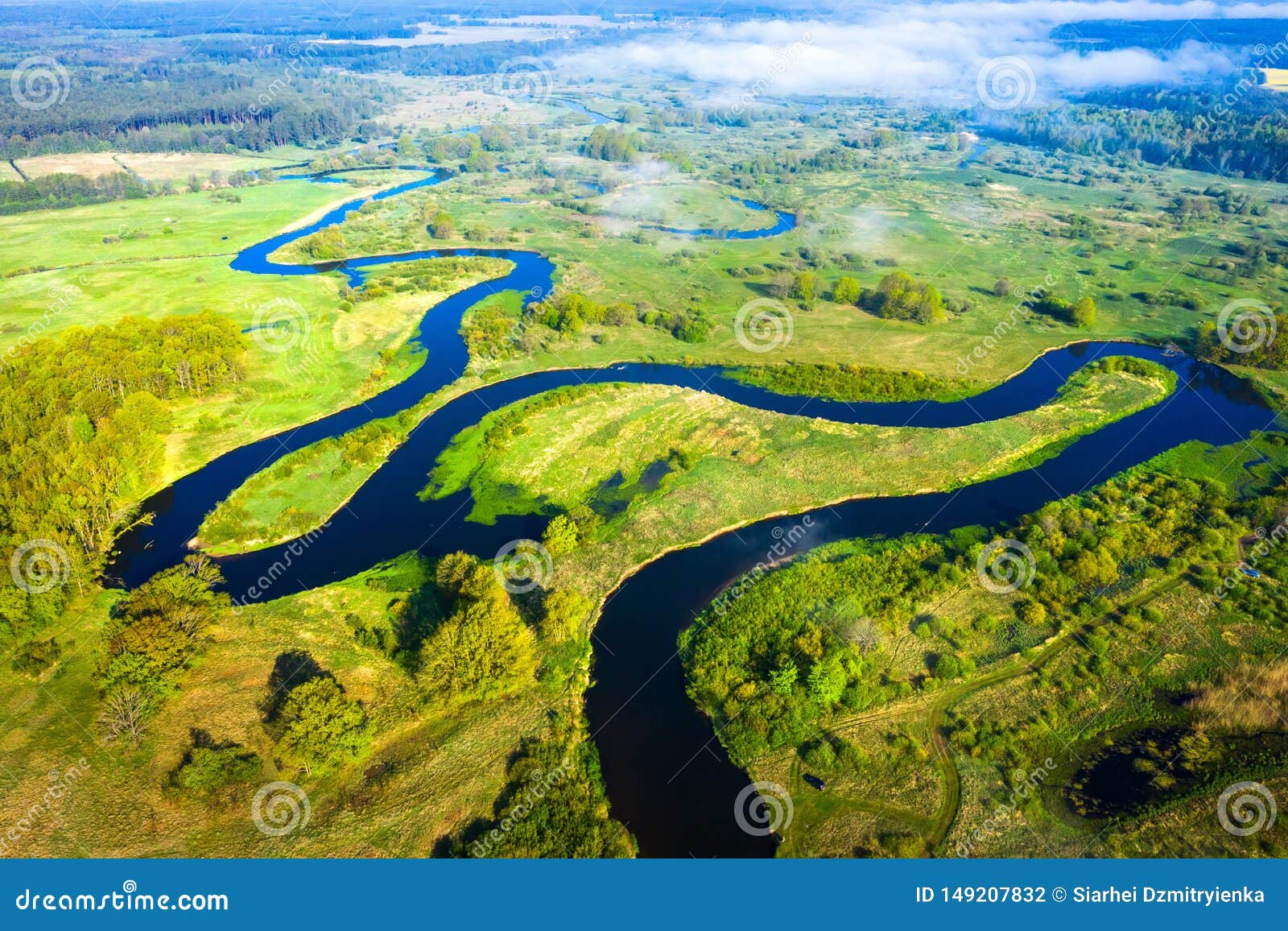 Aerial view on summer river. River stream on green meadow. Summer nature landscape. Drone view on riverside