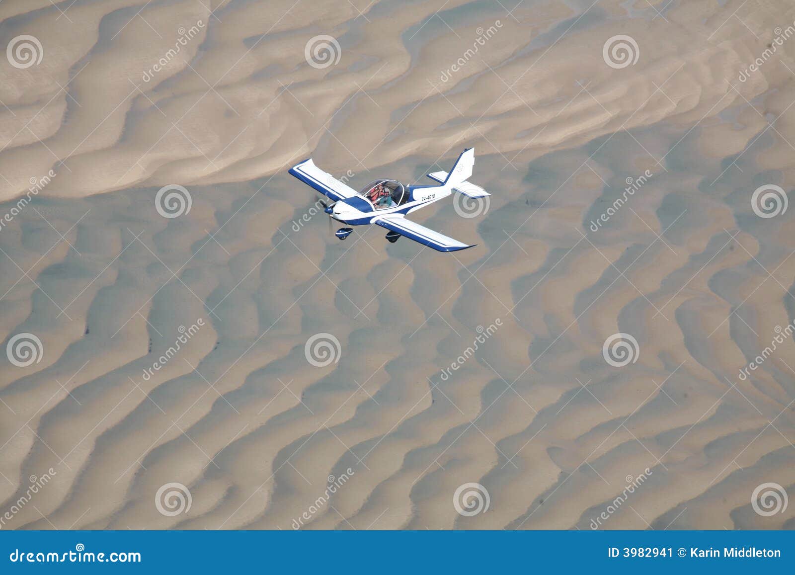 Flying aircraft over sand stock image. Image of adventure 3982941