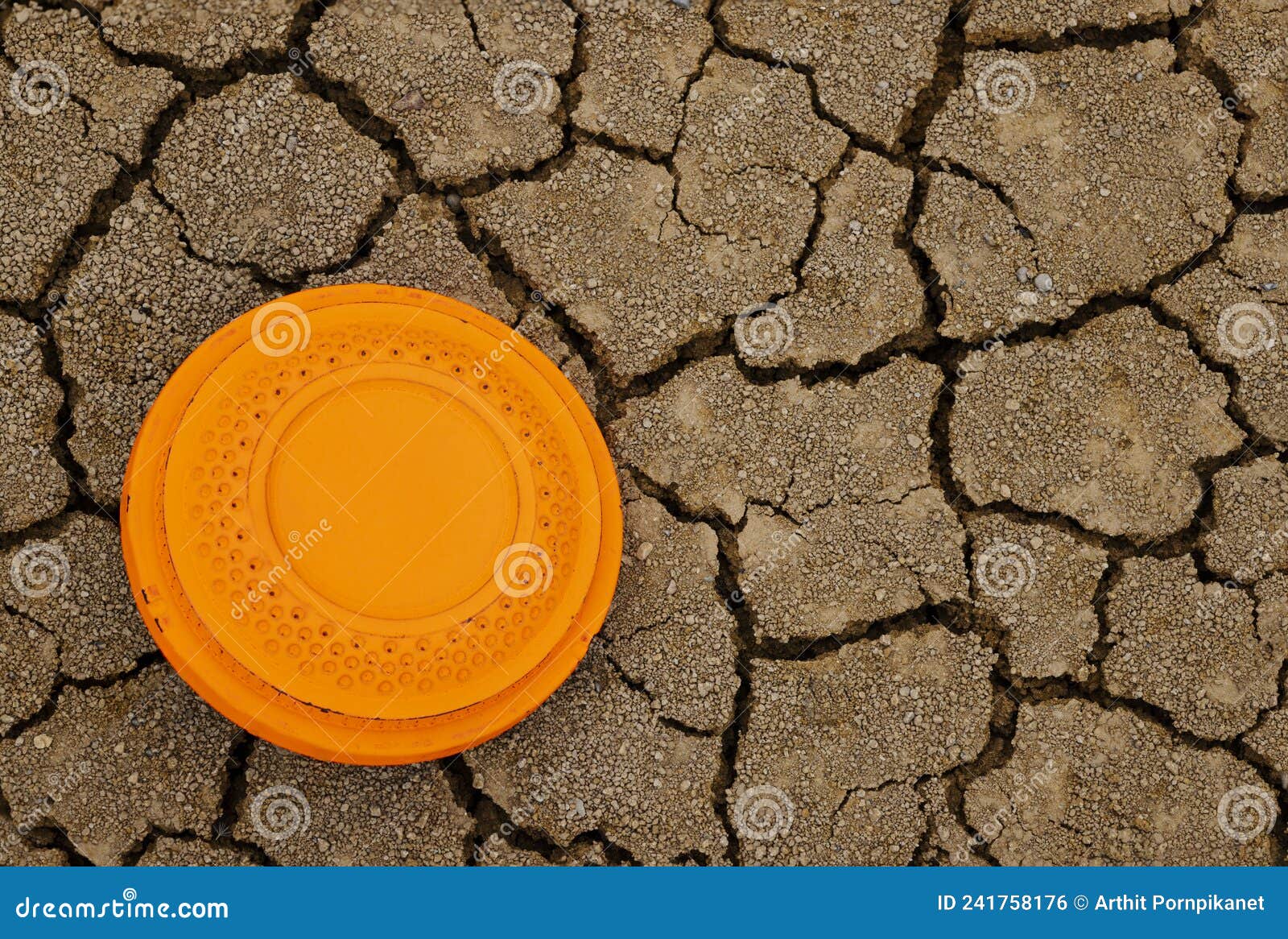 Flying Disk Target on Dried Cracked Soil Texture Background , Clay Shooting Game Stock Photo