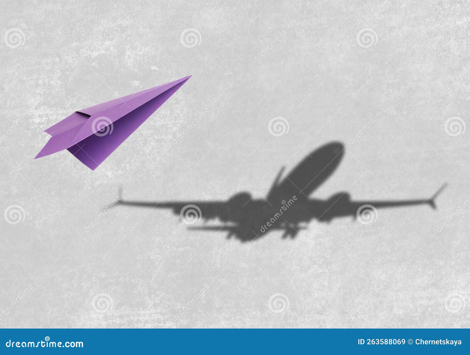 Flying Paper Plane and Shadow of a Real Airplane on Grey Background ...