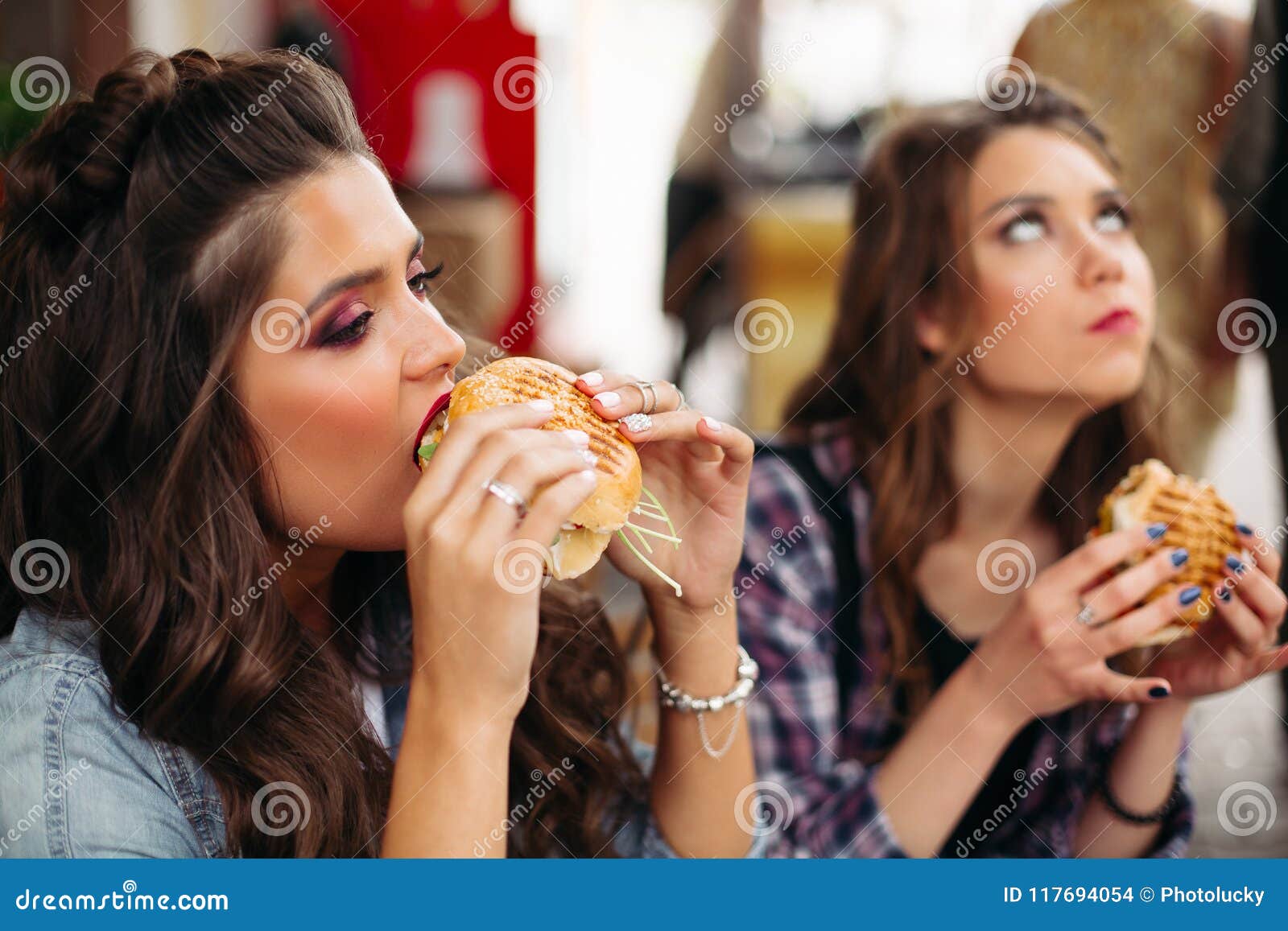 Teen Girls Enjoying Burgers 