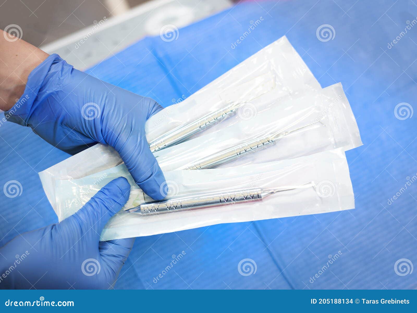 focus on doctor`s hands holding sealed sterile tools  carver . the concept of sterility