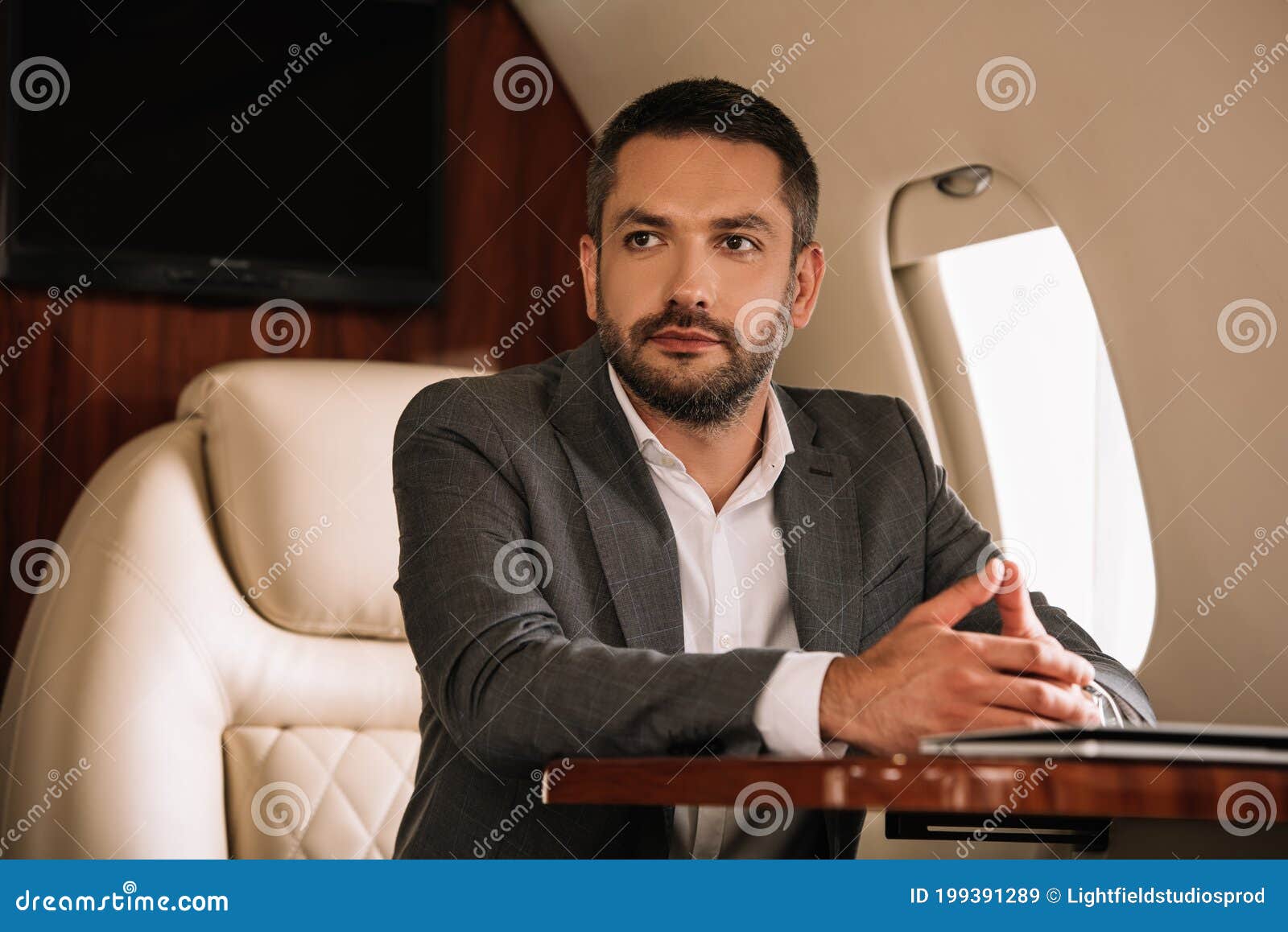 Focus of Handsome Businessman Sitting with Clenched Hands in Private Jet Stock Image Image of