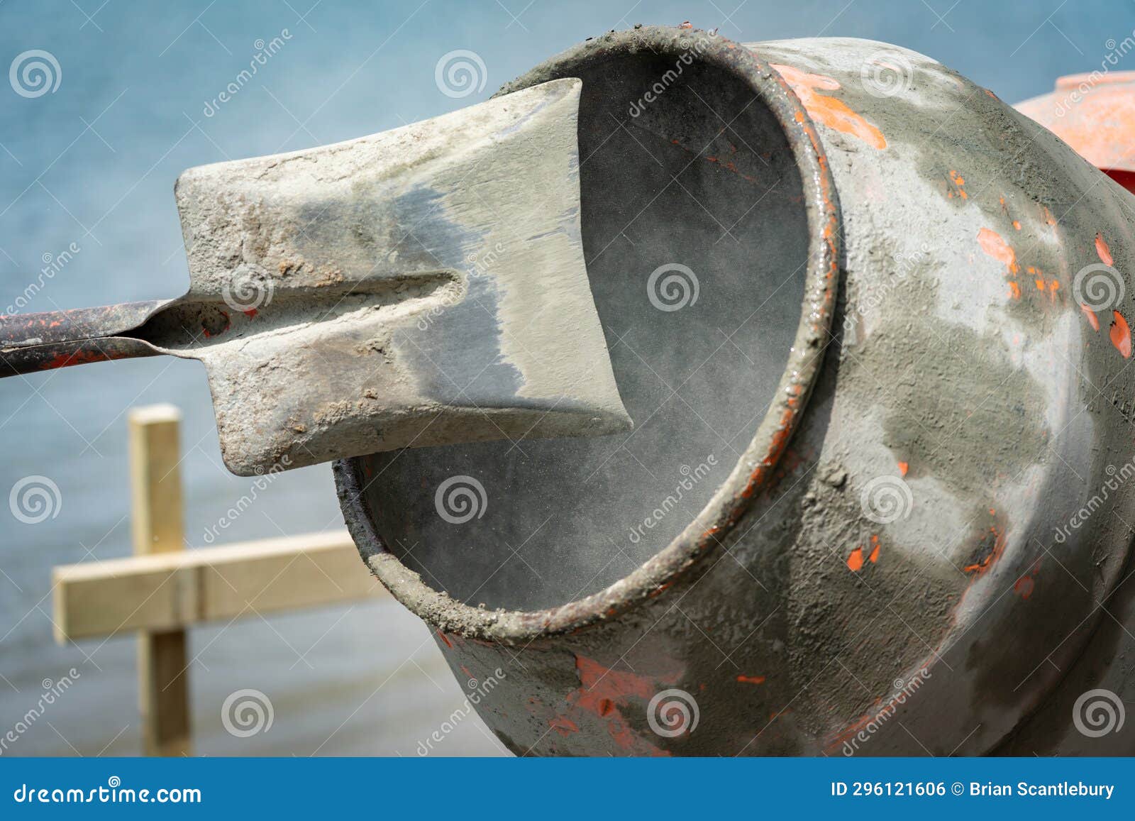 Focus on Inside Concrete Mixer Turning Blurred in Motion with Shovel