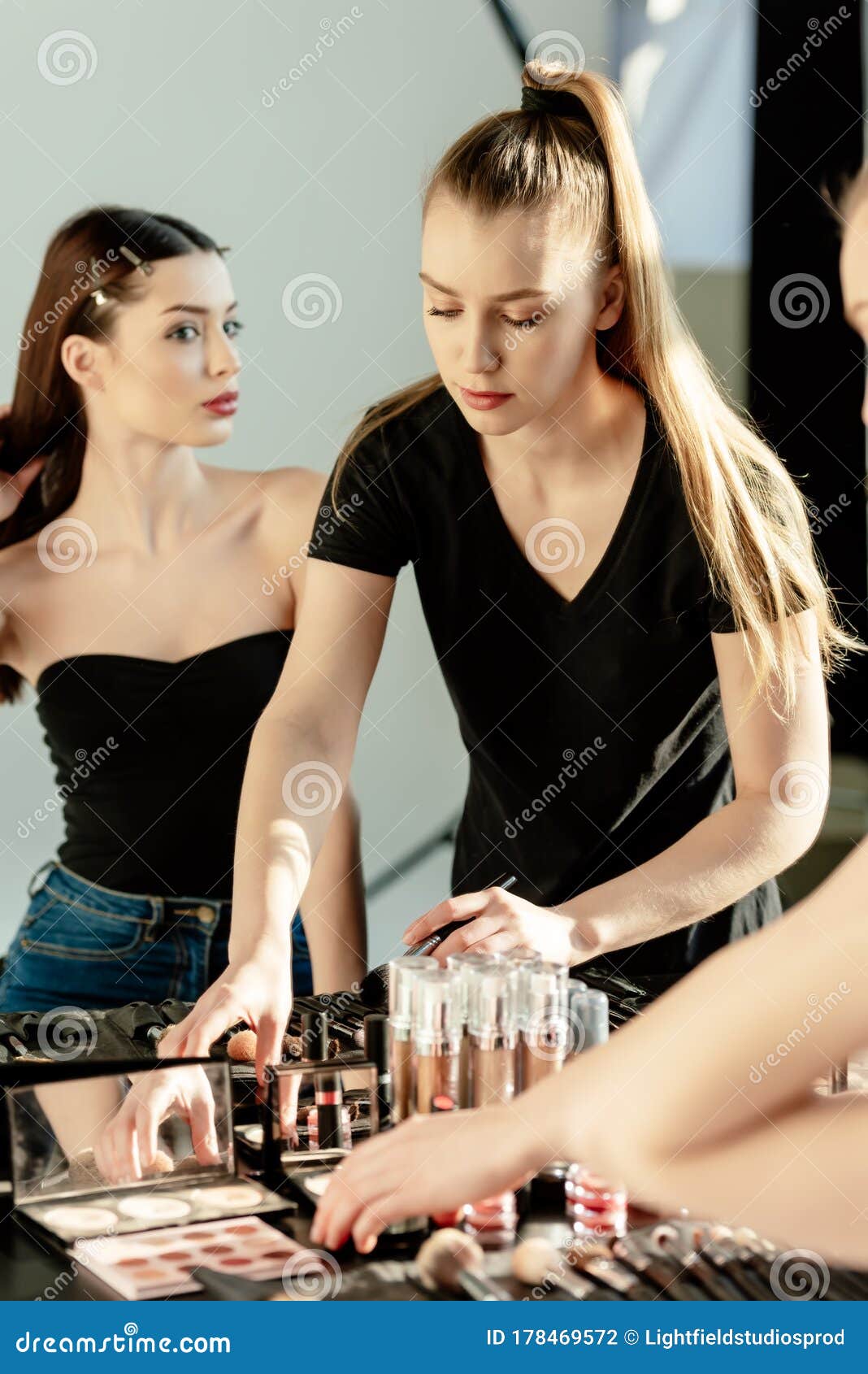 Focus of Make Up Artist Touching Decorative Cosmetics Near Model Stock