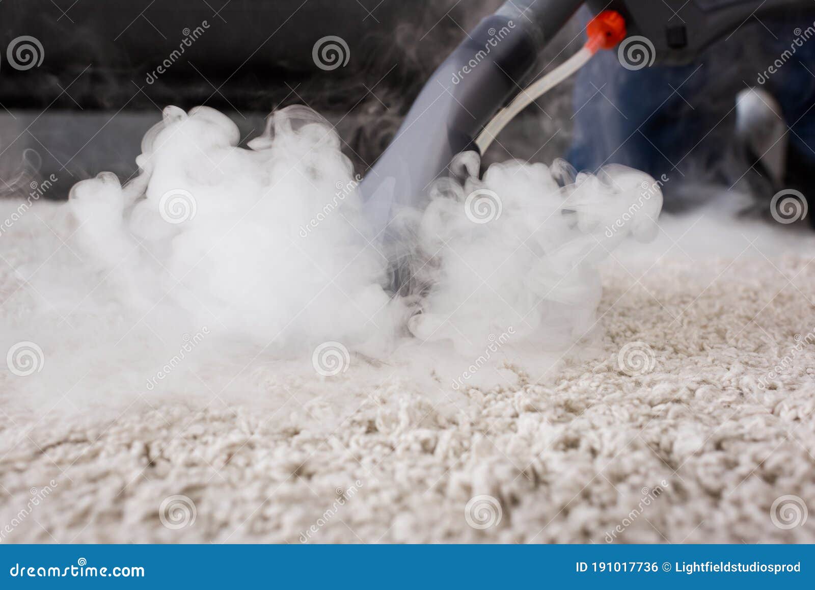 Focus of Vacuum Cleaner with Hot Steam on Carpet at Home Stock Photo