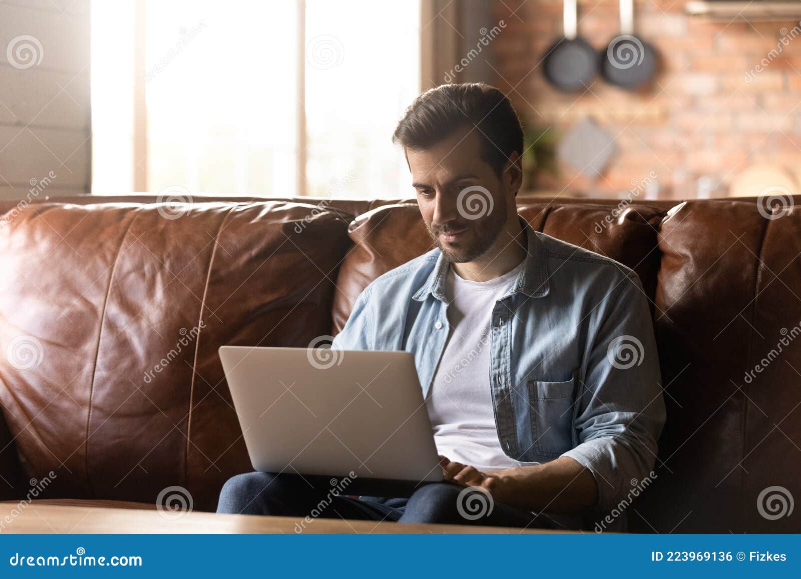 focused adult student, remote employee using laptop