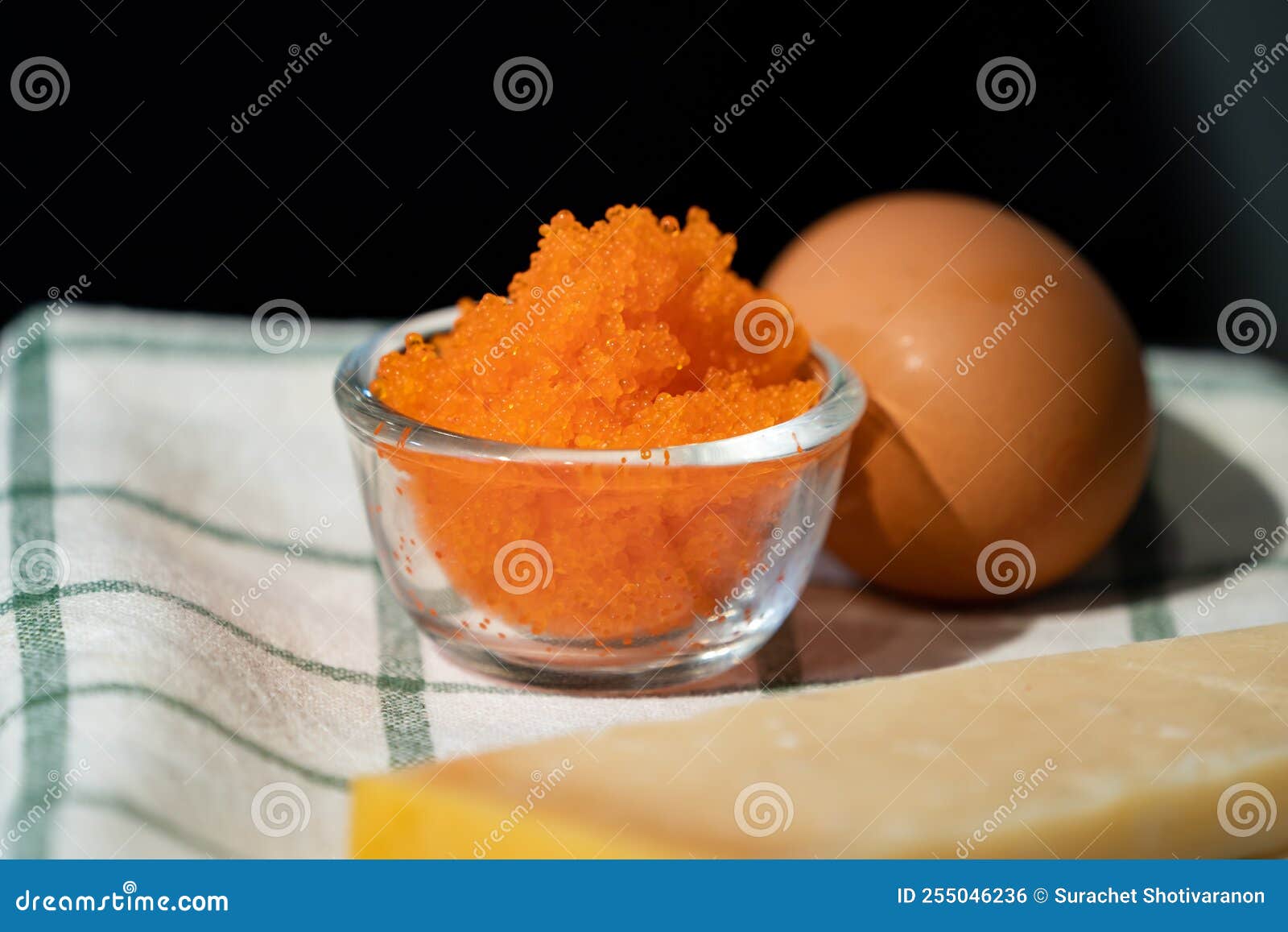 Focused on Fresh Tobiko, Flying Fish Roe with Blur Egg beside it Stock