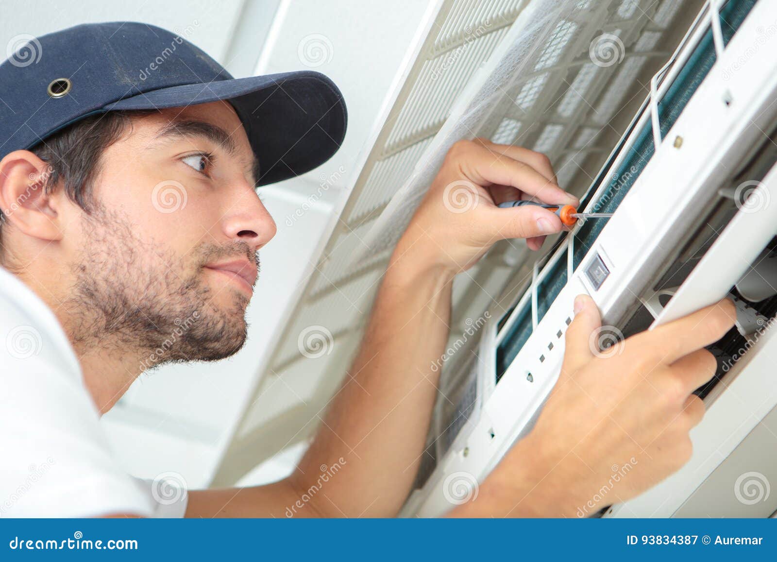 Focused Handyman Testing Air Conditioning on Wall Stock Image Image