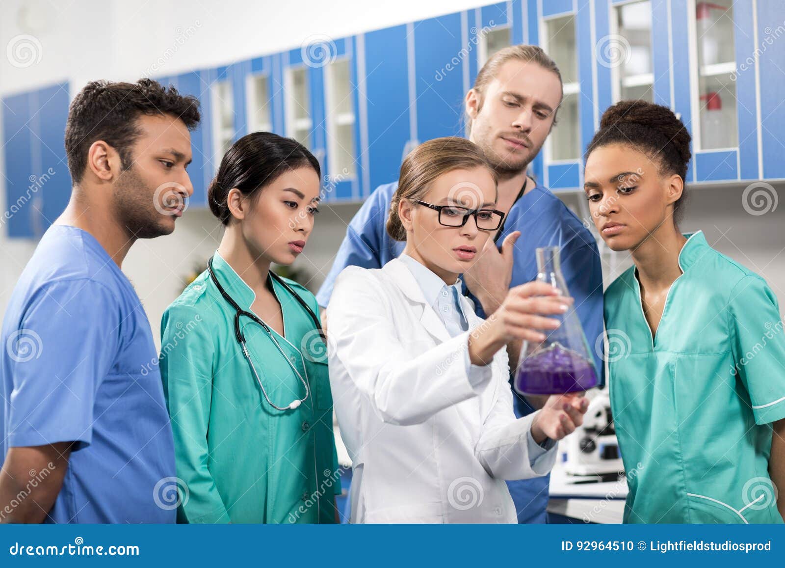 Focused Medical Workers Anakyzing Test Tube in Laboratory Stock Photo