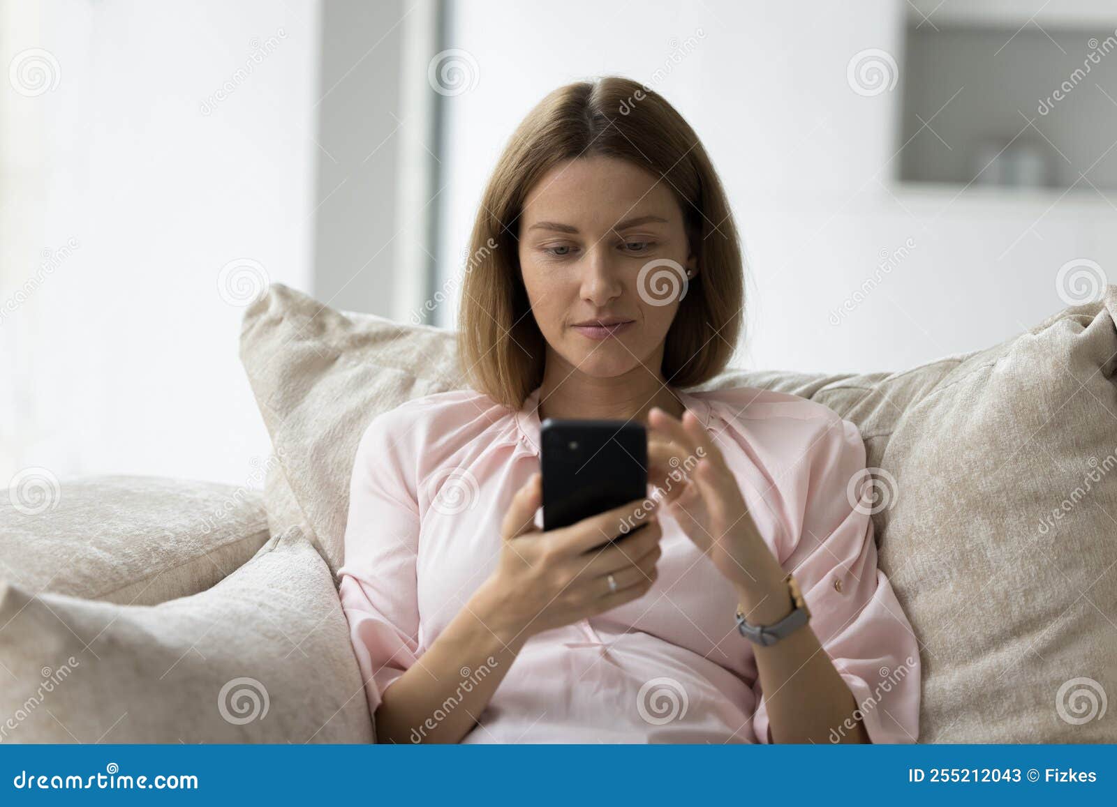 focused pensive 30s smartphone user woman chatting, typing message