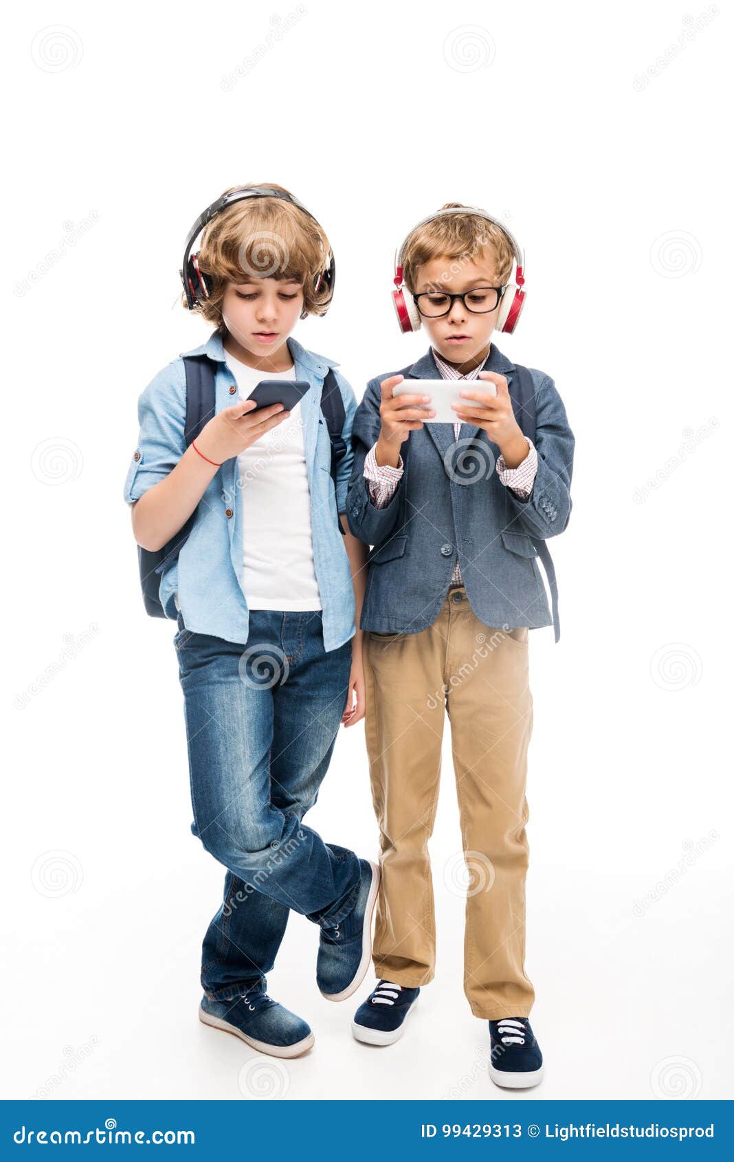 focused schoolboys using smartphones