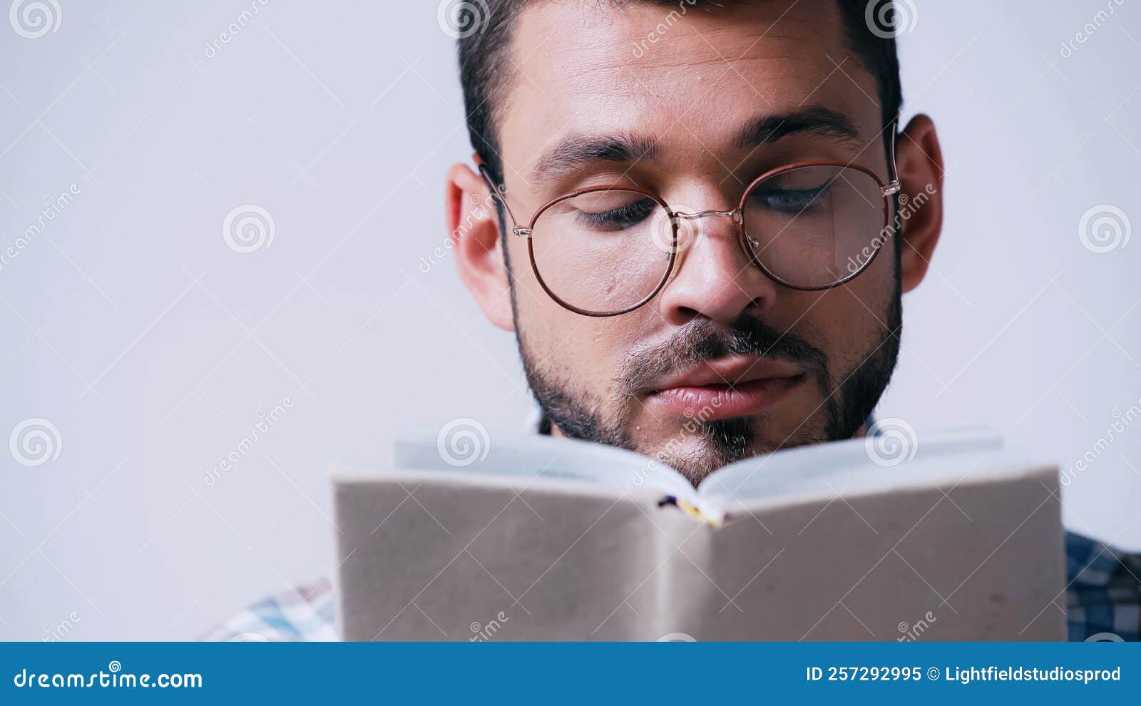 Focused Student in Eyeglasses Reading Blurred Stock Image Image of
