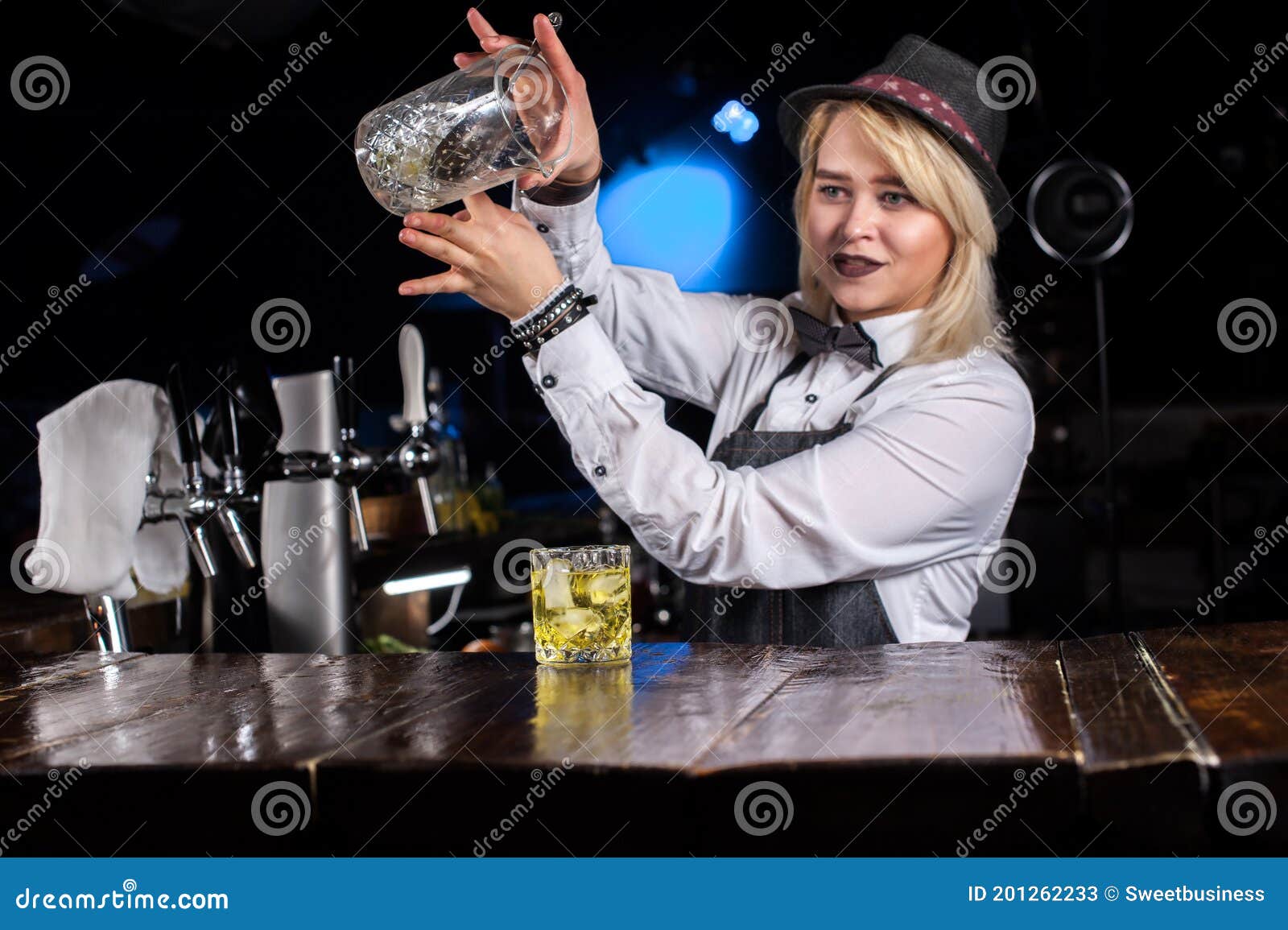 Pretty Girl Bartending Adds Ingredients To a Cocktail Behind Bar Stock ...