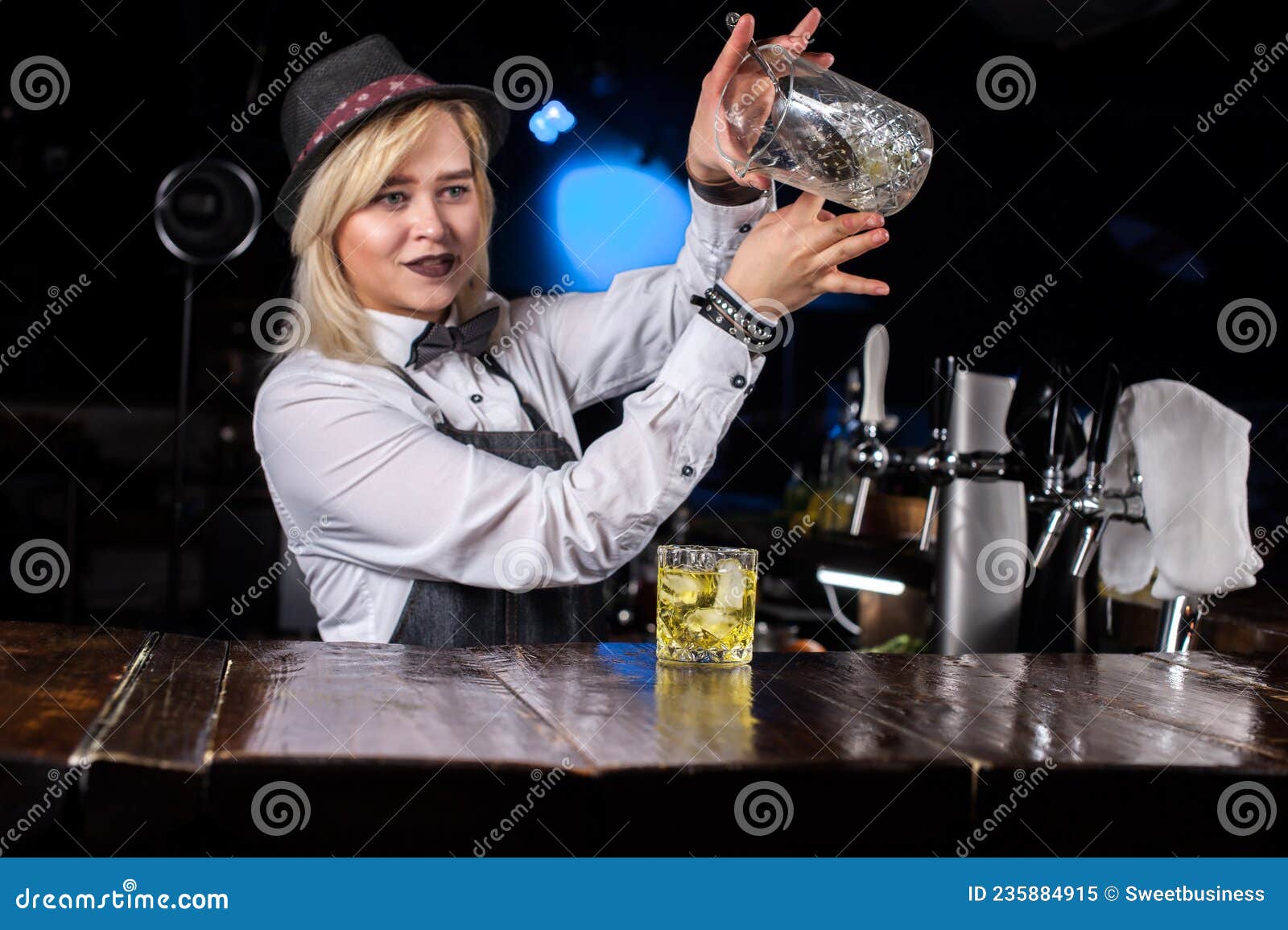 Pretty Girl Bartending Adds Ingredients To a Cocktail Behind Bar Stock ...