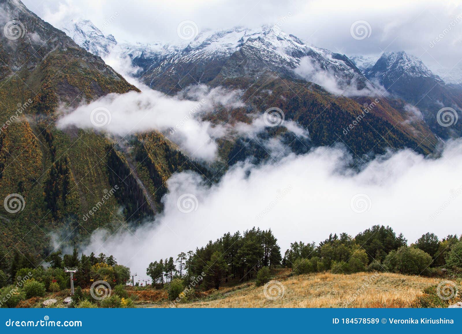 fog in the mountains, scenic view from the mount mussa achitara in dombay ski resort in autumn season, caucasus, russia