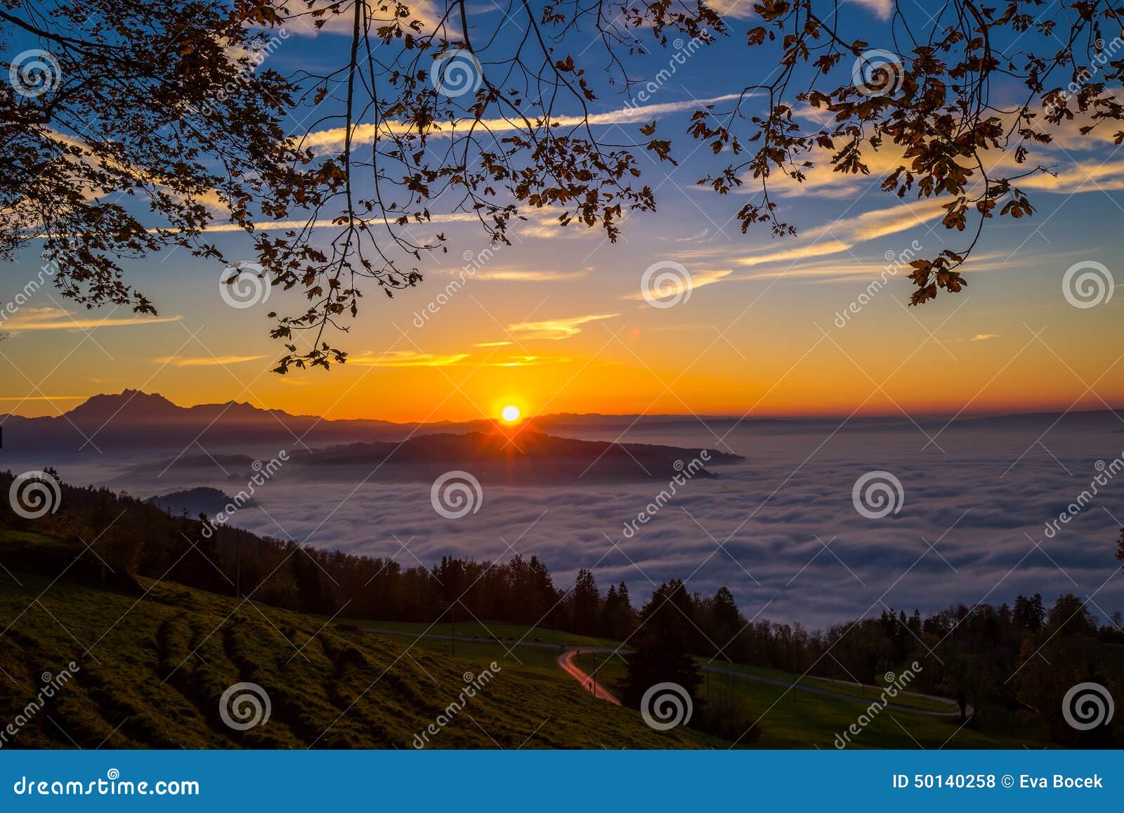 fog surrounding town zug and zugersee during the sunset