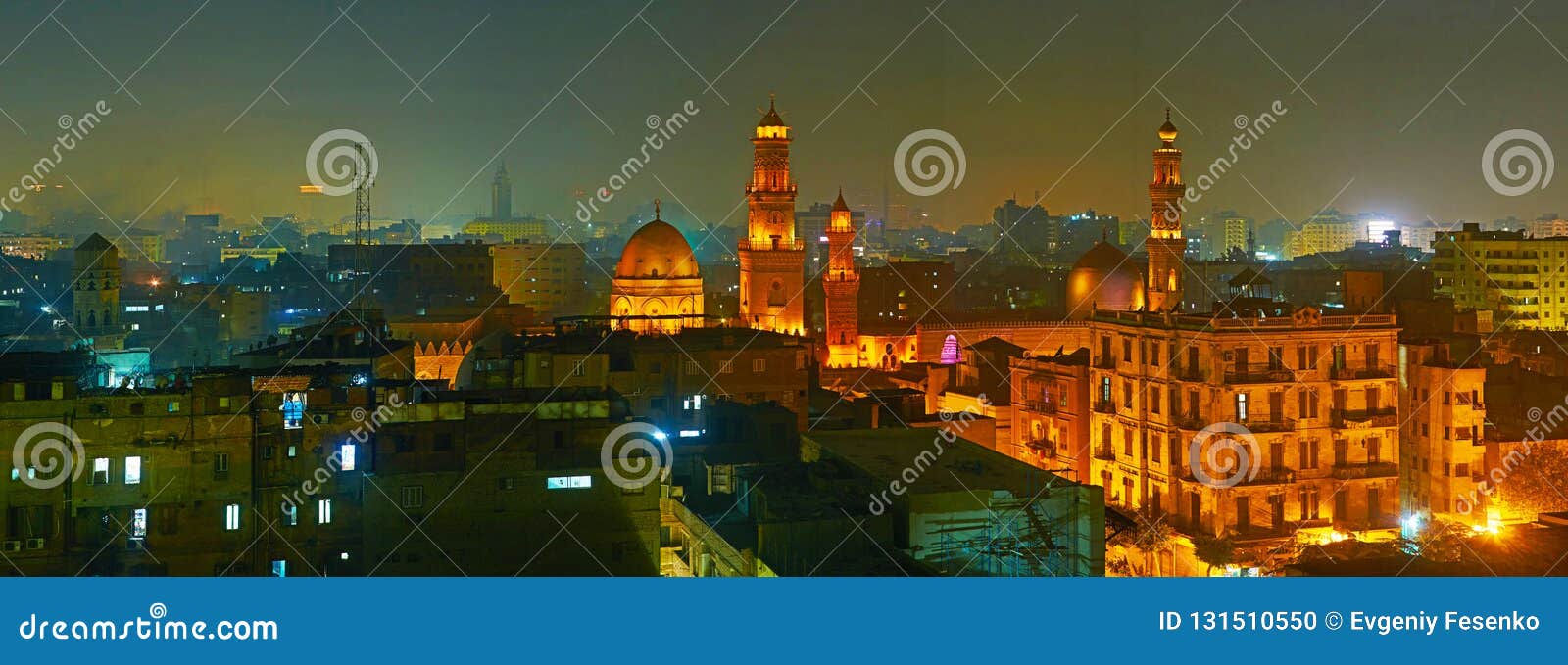 the foggy evening in islamic cairo with a view on medieval minarets and domes of sultan qalawun, al moez and elzaher barqooq