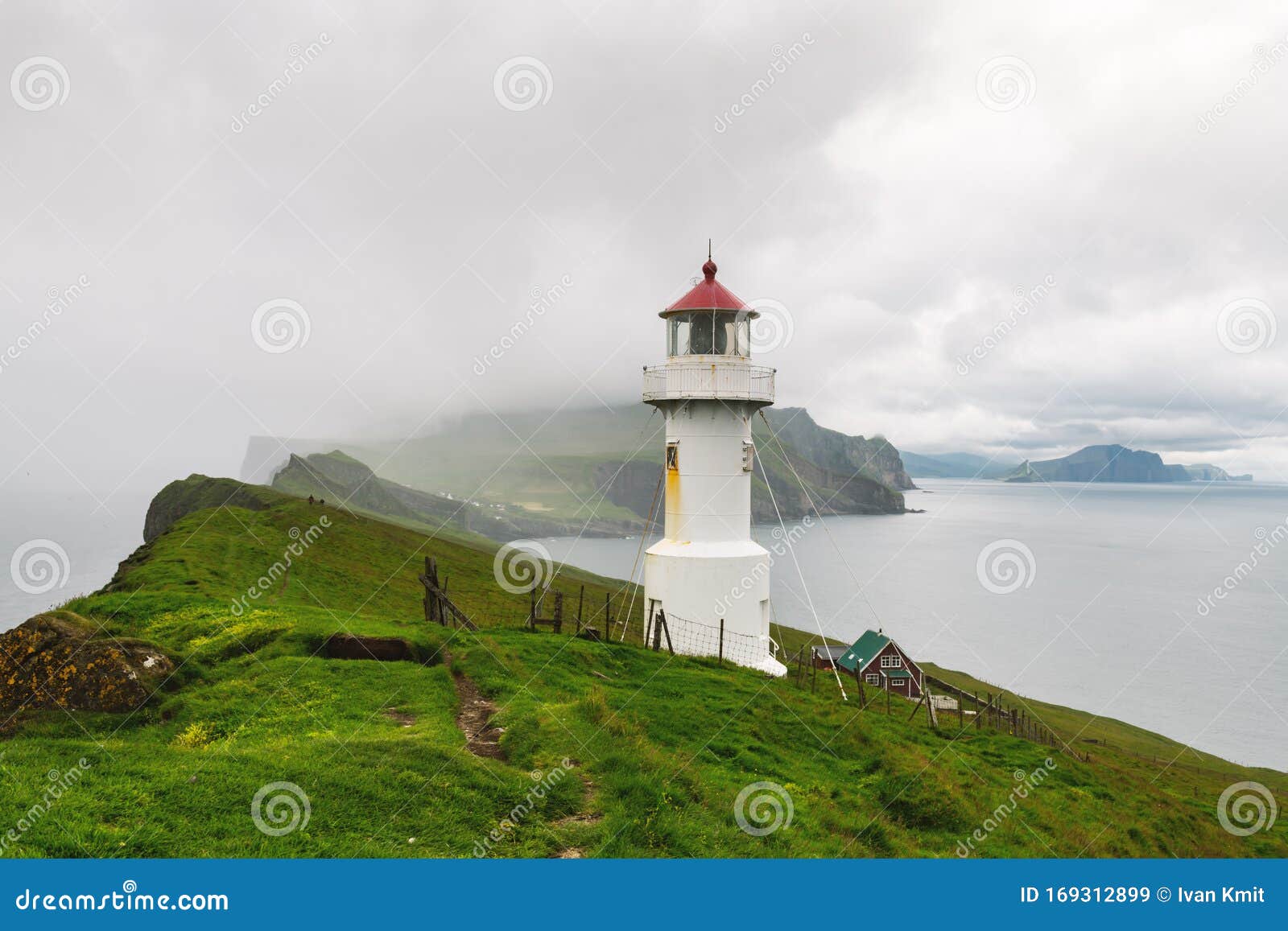 foggy view of old lighthouse on the mykines island
