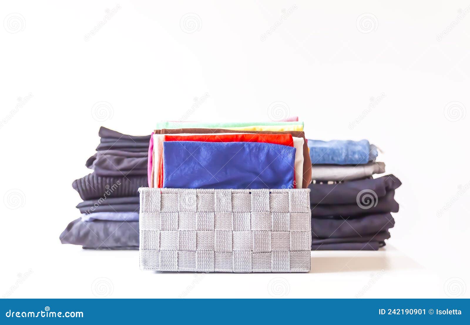 Folded Colorful Clothes in a Box. Home Organizing. Domestic Vertical