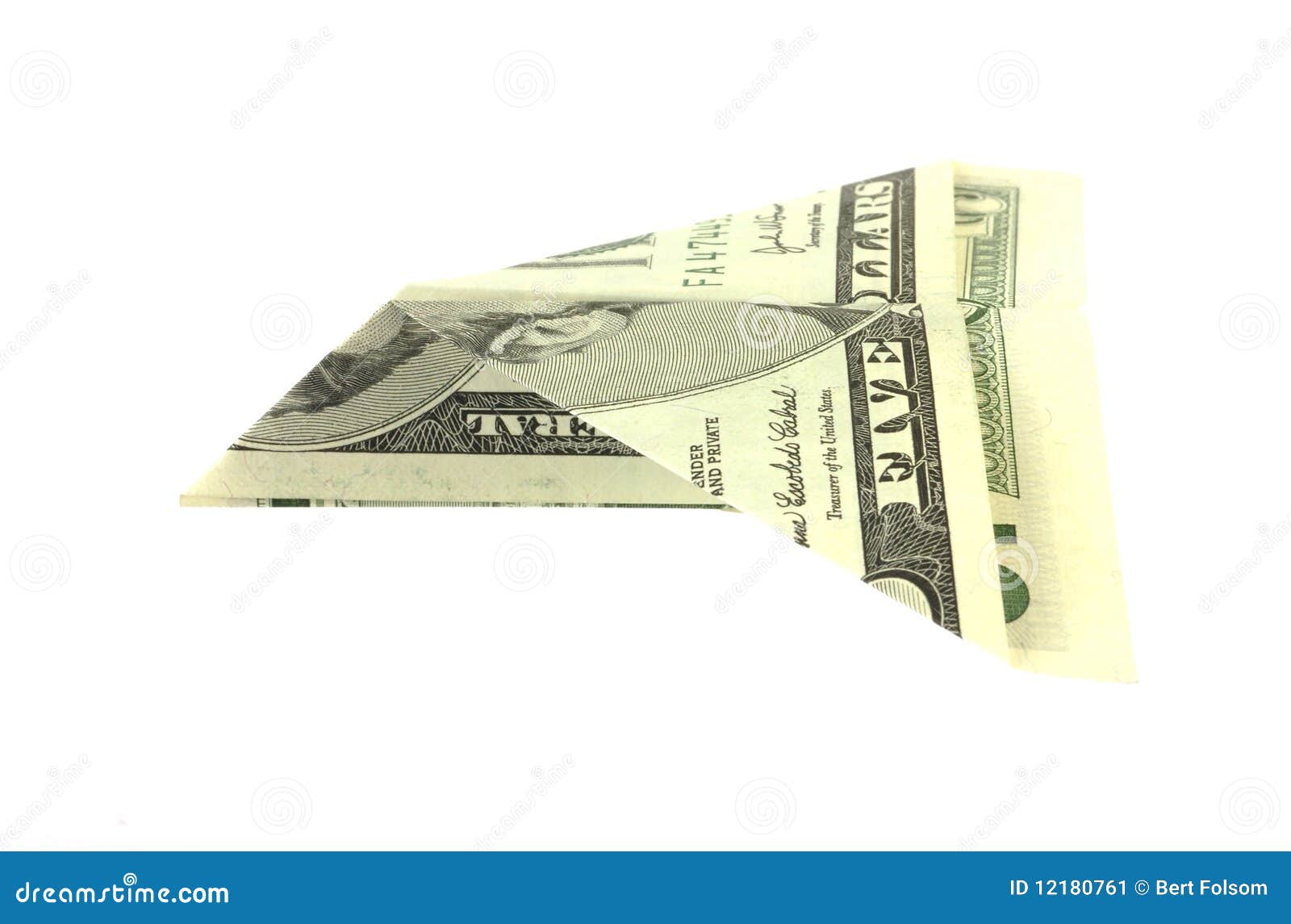 Folded five dollar bill paper airplane. A five dollar bill folded in the shape of an airplane against a white background.