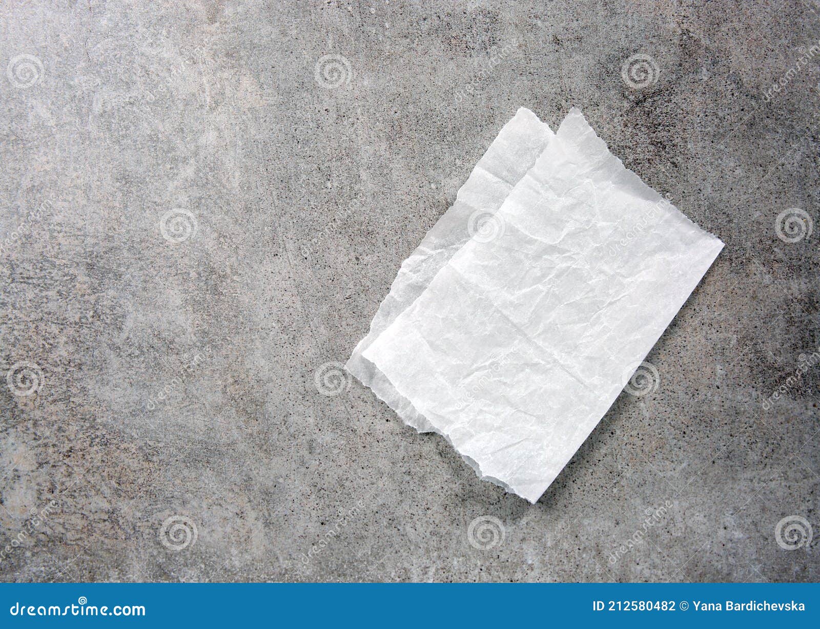 folded white paper napkin on grey stone table top view,food advertisement  empty space