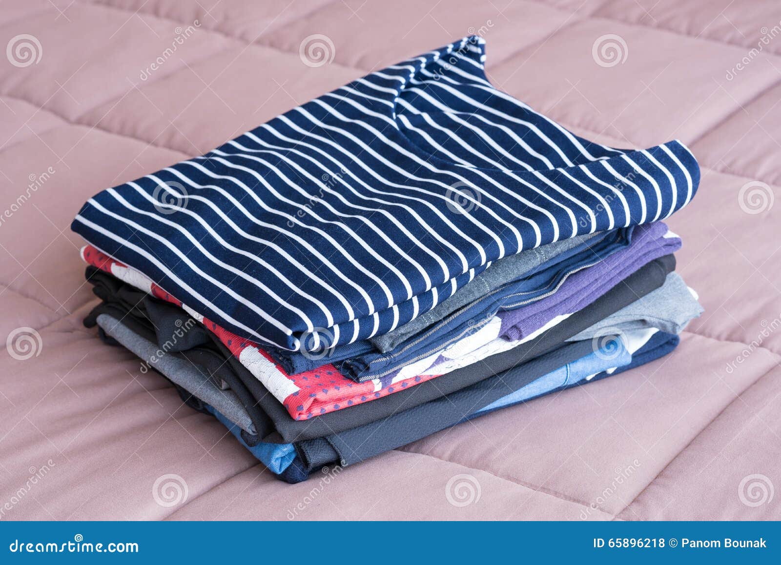 Folding Clothes on the Bed before Keeping in Wardrobe Stock Photo ...