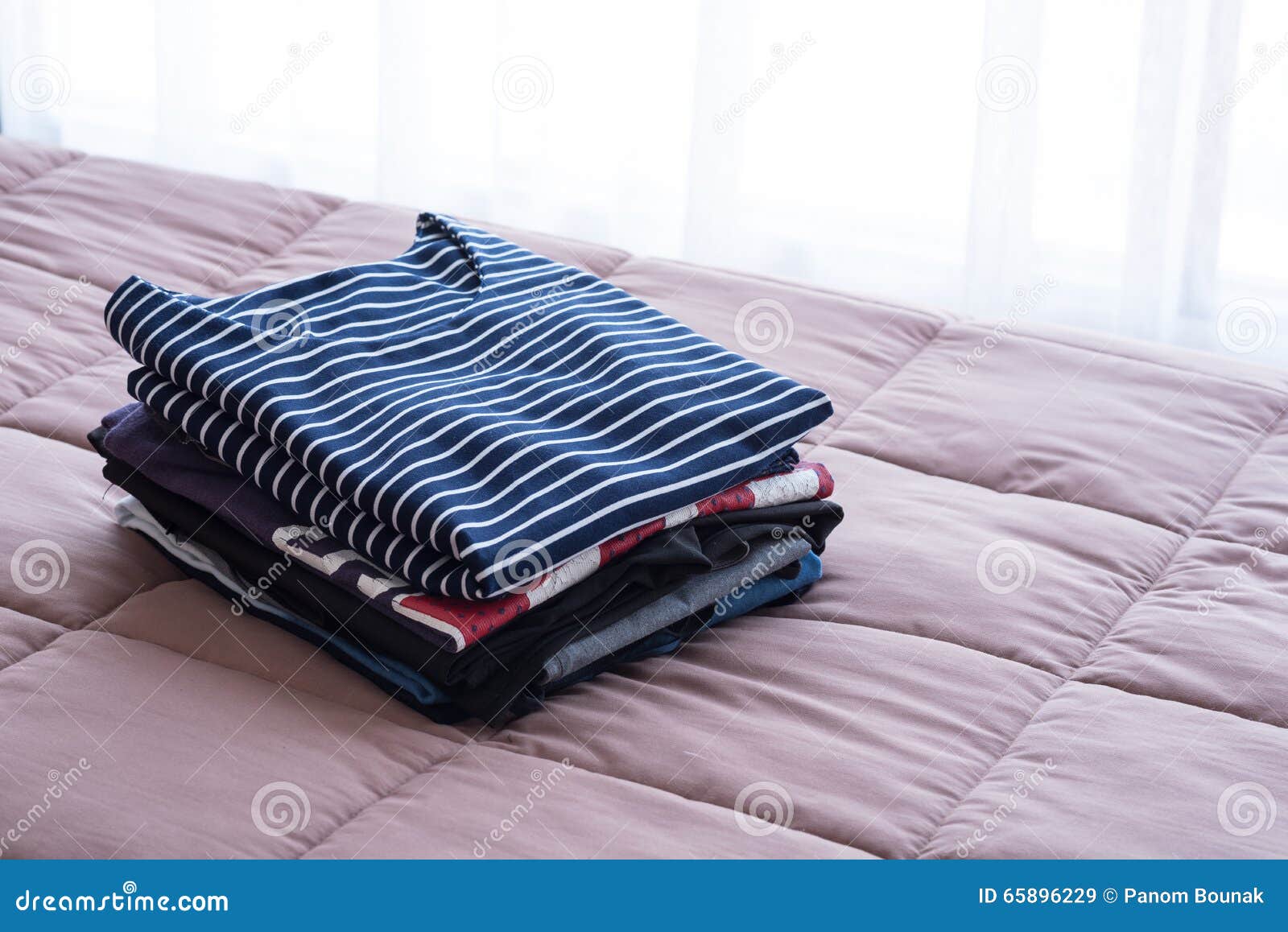 Folding Clothes on the Bed before Keeping in Wardrobe Stock Image ...