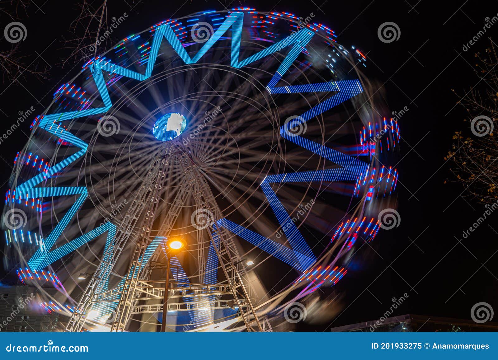 fonte nova`s garden with christmas market and colored ferris wheel near ria de aveiro at night