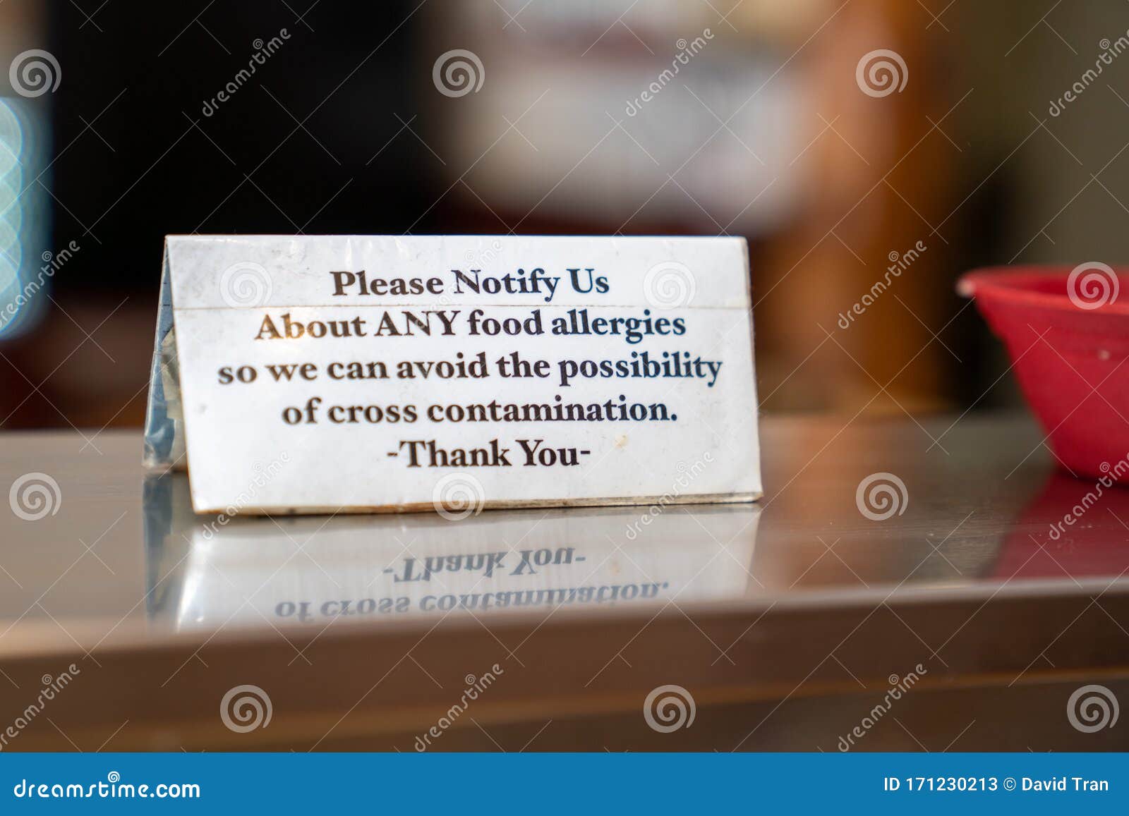 food allergy cross contamination warning placard notice sitting on stable at restaurant