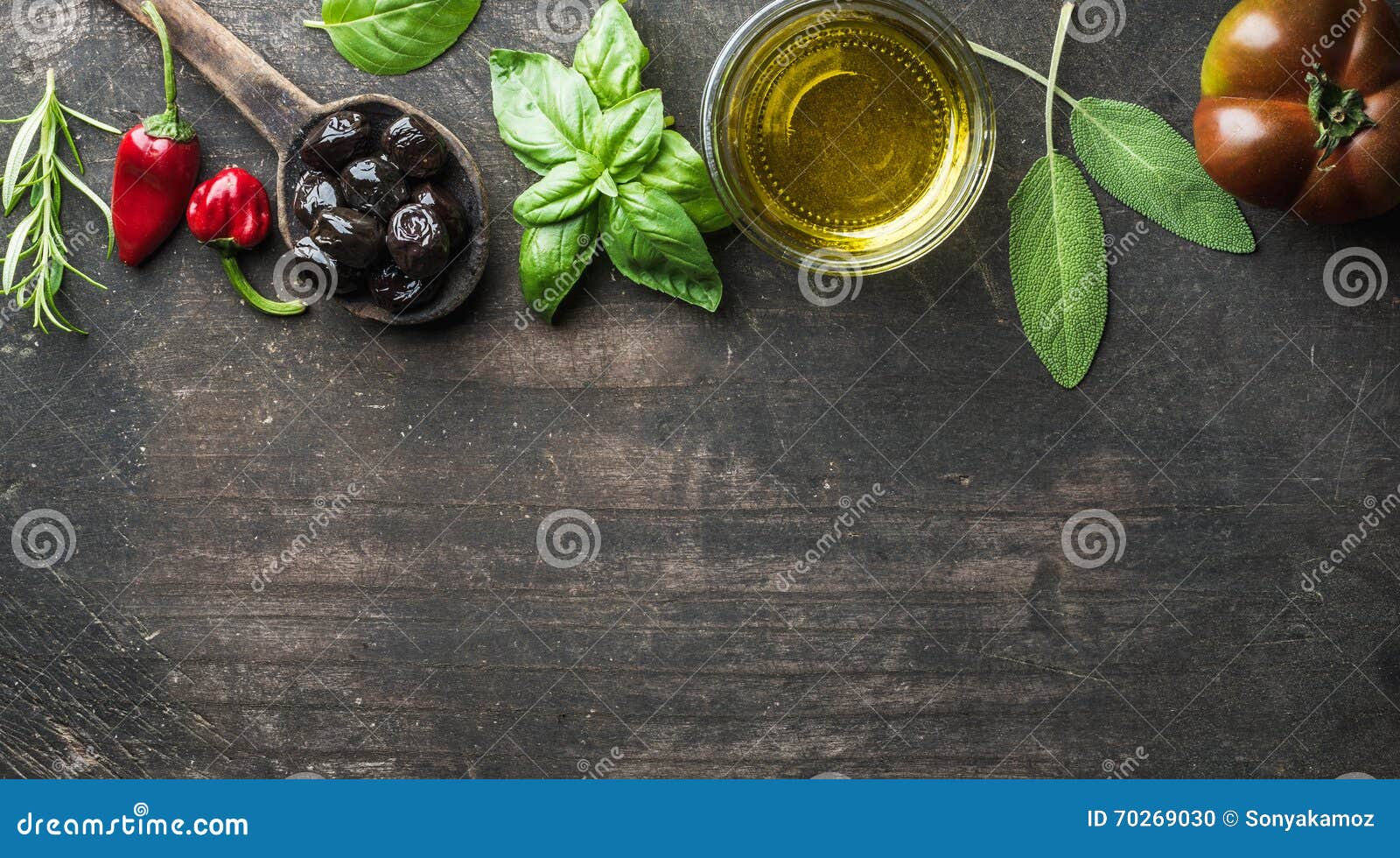 food background with vegetables, herbs and condiment. greek black olives, fresh basil, sage, rosemary, tomato, peppers