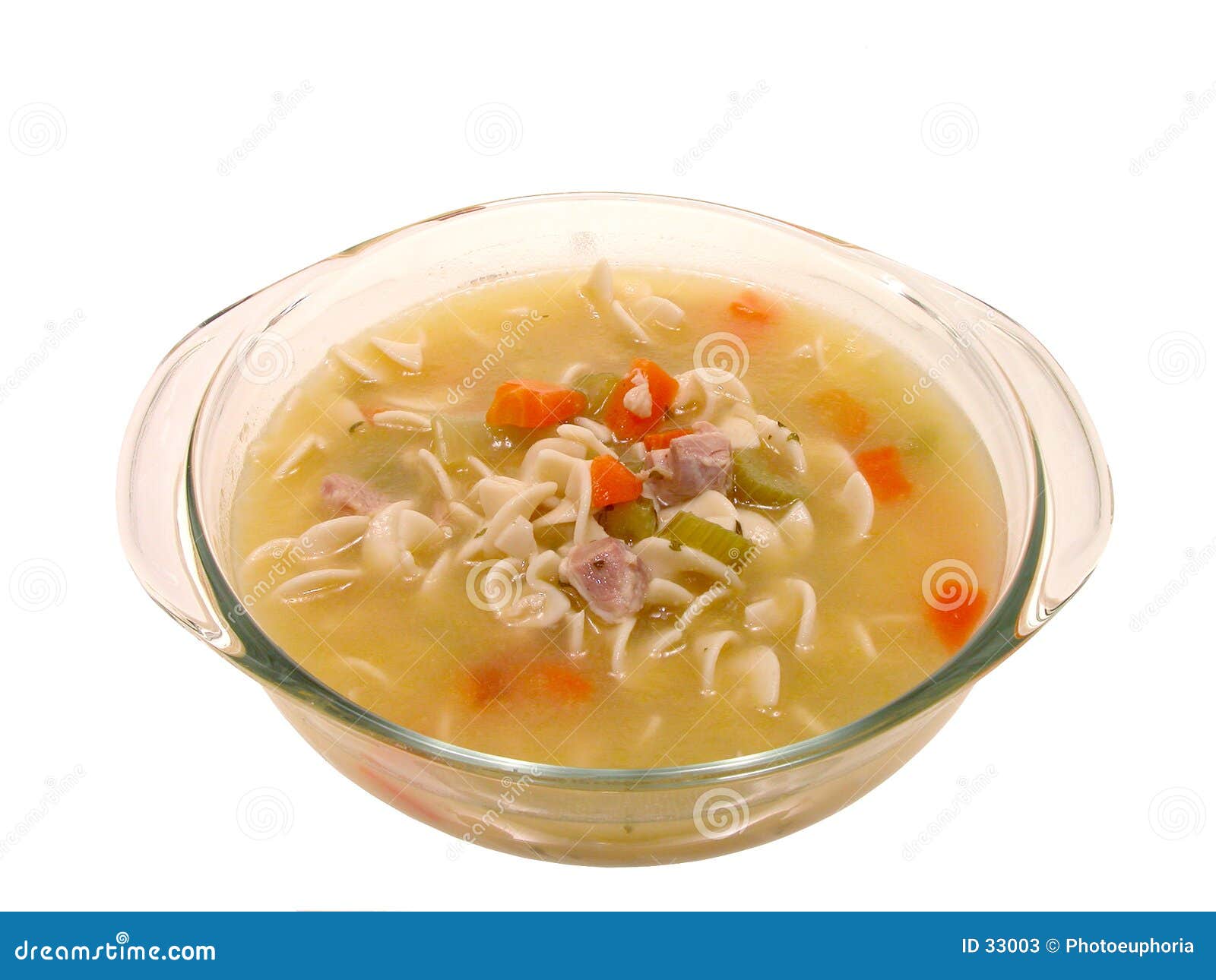 food: chunky chicken noodle soup in glass cooking dish