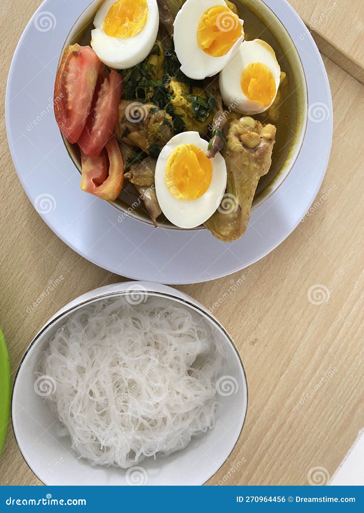 Food in the Form of White Noodles, Chicken Meat, and Eggs Stock Photo