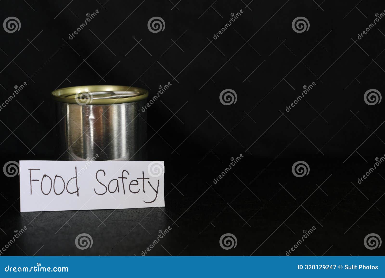 Food Safety Concept. Labeled Canned Food in Dark Black Background Stock