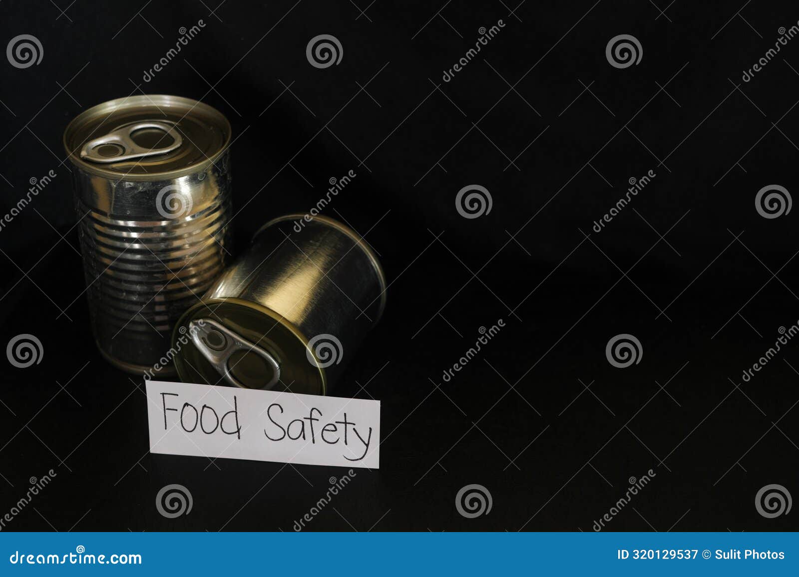 Food Safety Concept. Labeled Canned Food in Dark Black Background Stock