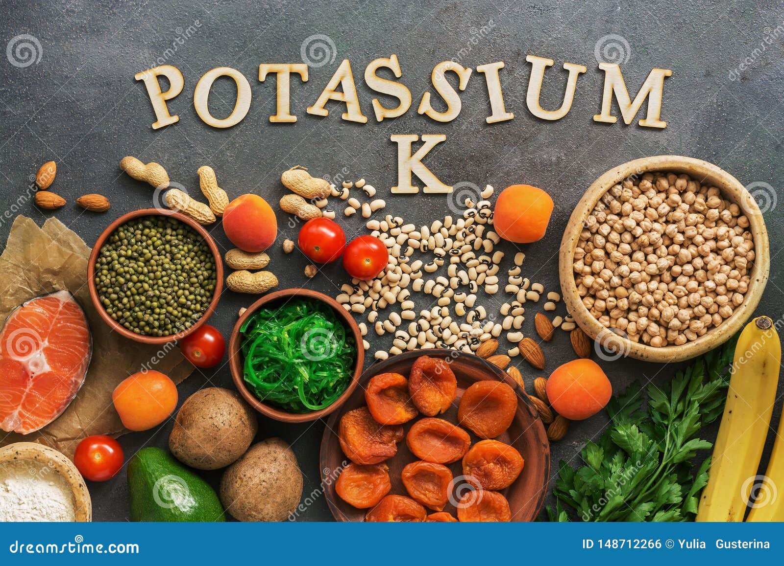 foods rich in potassium, salmon, legumes, vegetables, fruits on a dark background. healthy food concept,avitaminosis prevention.