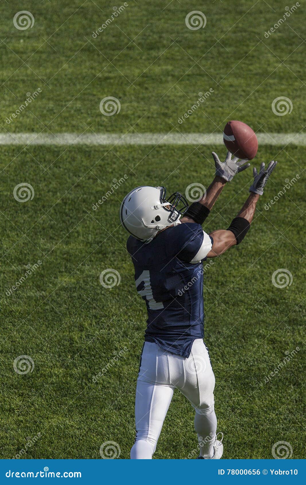 Football Action Photo of Athlete Catching a Touchdown Pass Stock Photo ...