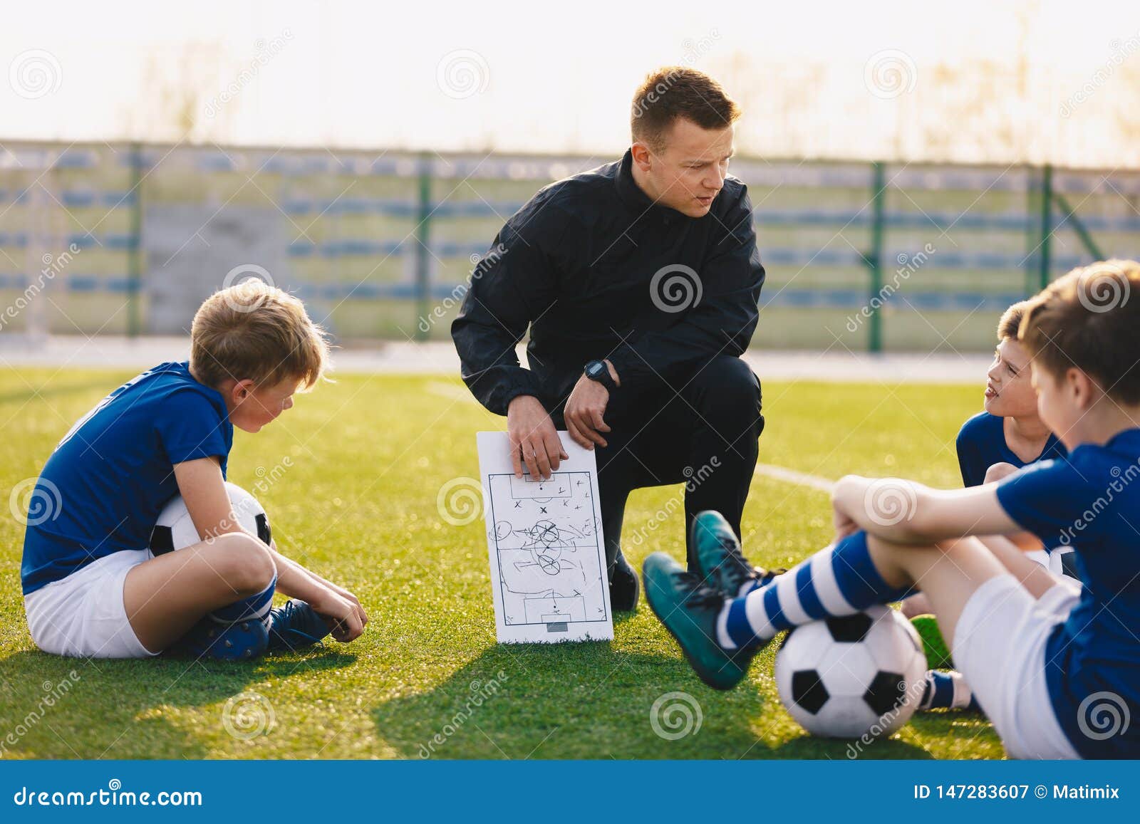 Coach Is Coaching Children Training In Soccer Team Stock Photo, Picture and  Royalty Free Image. Image 65309590.